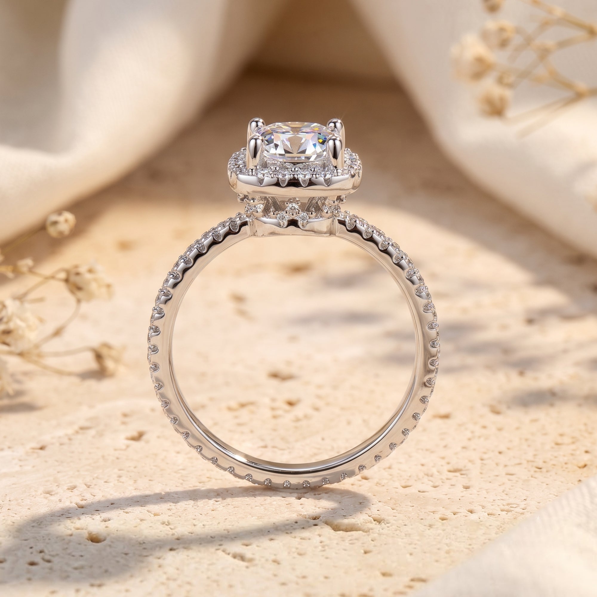 Side profile of a sterling silver cushion halo ring showing the stone setting and pavé band.