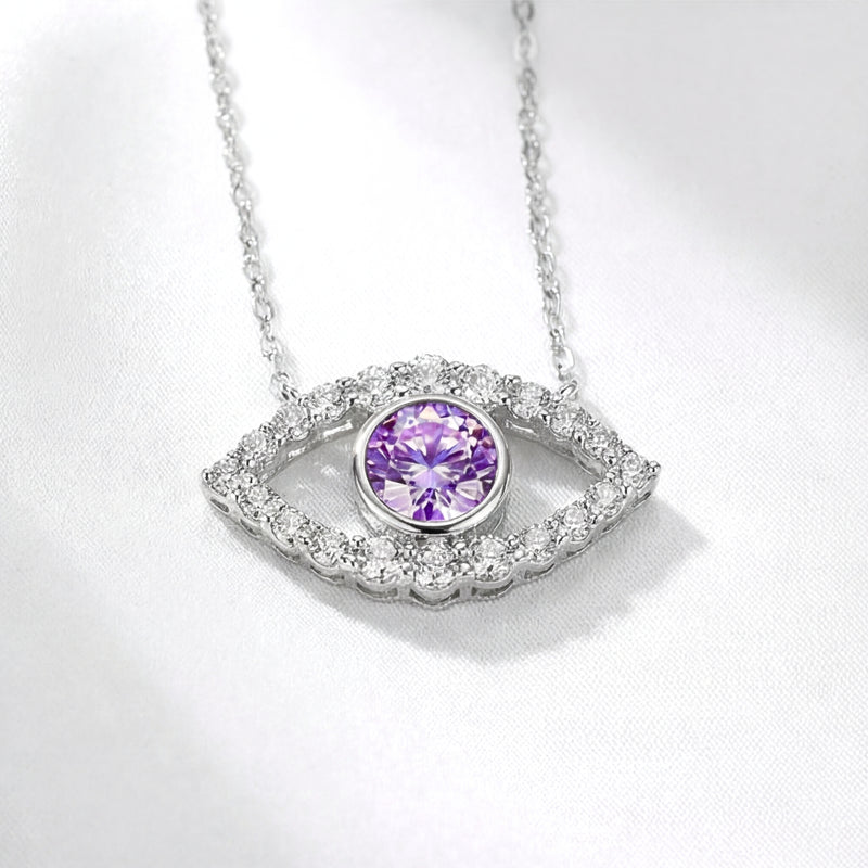 Macro view of the sterling silver evil eye pendant with a round simulated amethyst and moissanite halo.