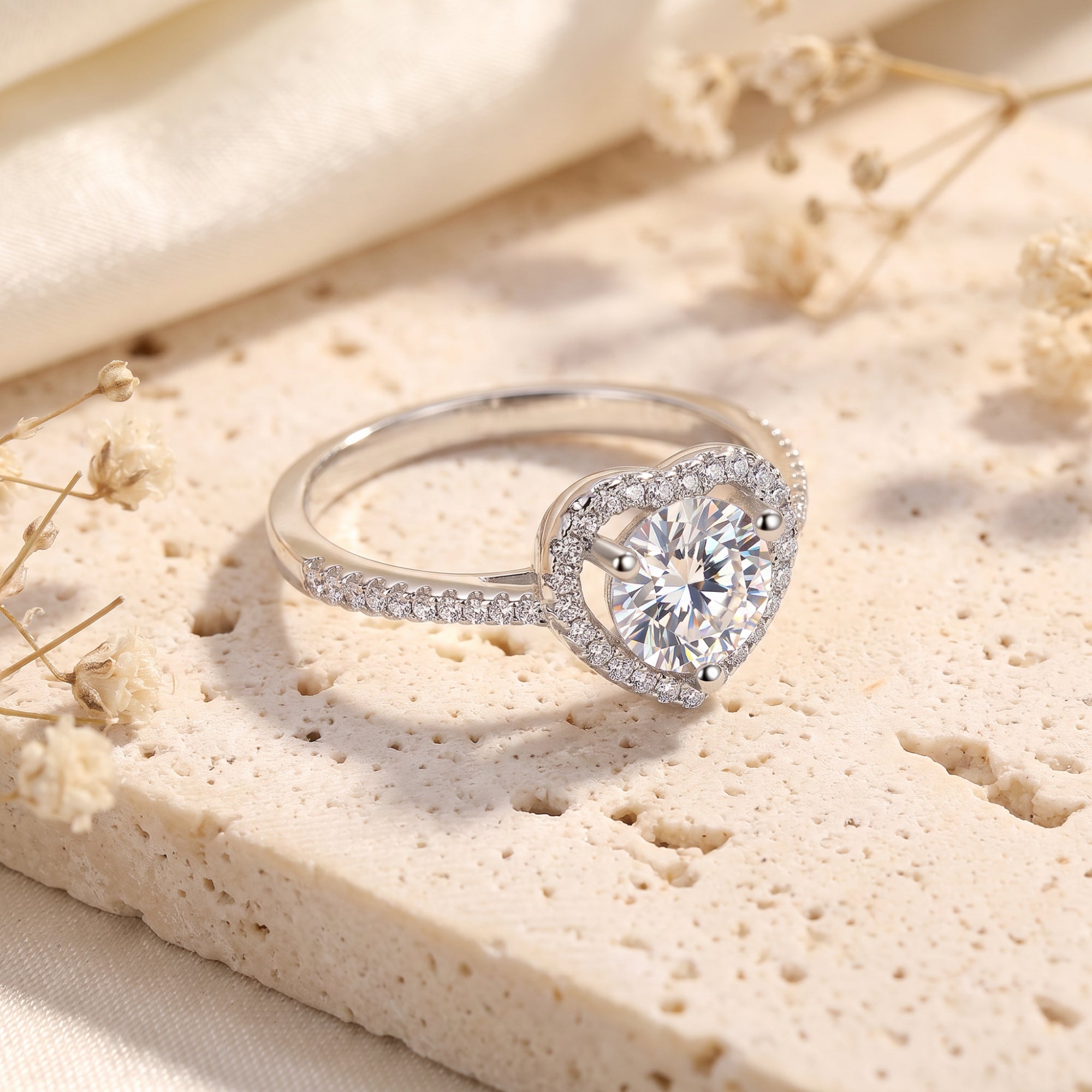 Side view of an S925 sterling silver heart halo ring with a round cubic zirconia center stone.