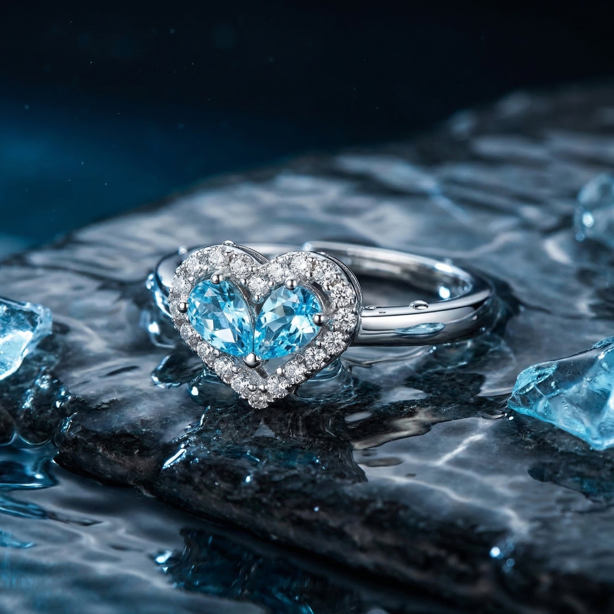 Close-up of the heart-shaped halo ring featuring two pear-cut natural aquamarines in a white gold setting.