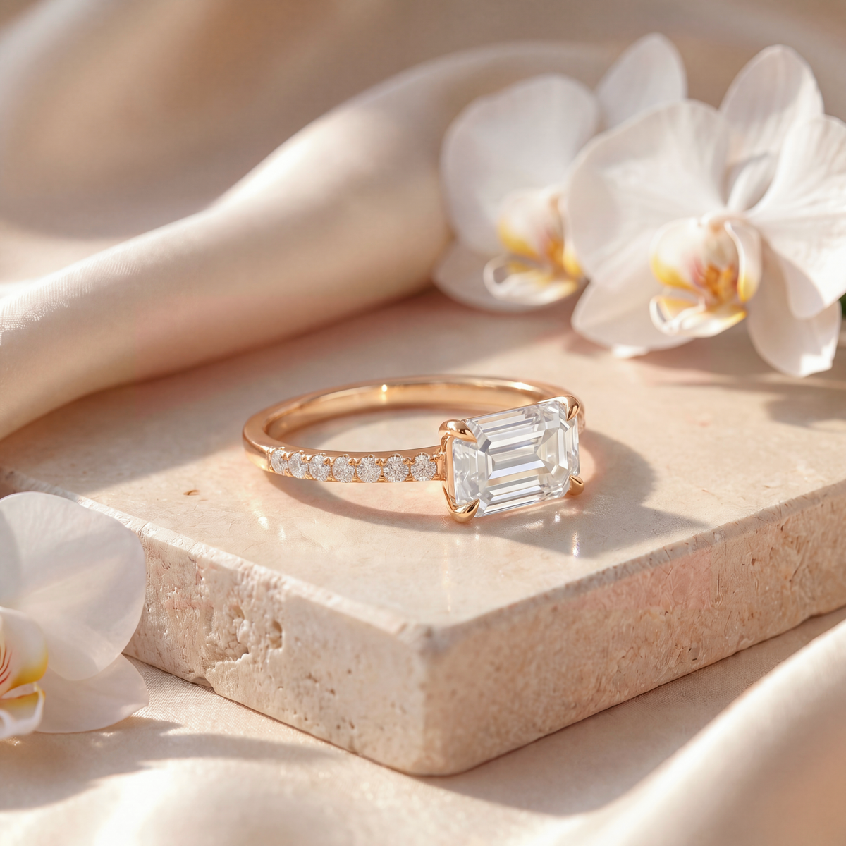 Angled perspective shot of a yellow gold east-west emerald-cut moissanite engagement ring.