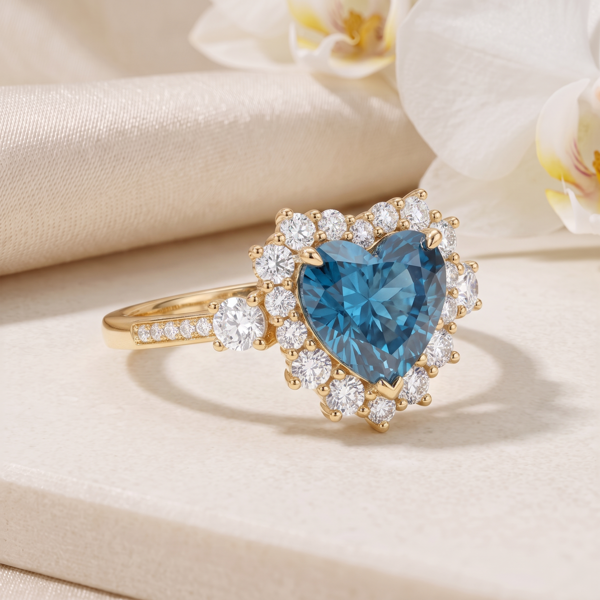 Angled view of a heart-shaped blue moissanite halo ring in yellow gold.