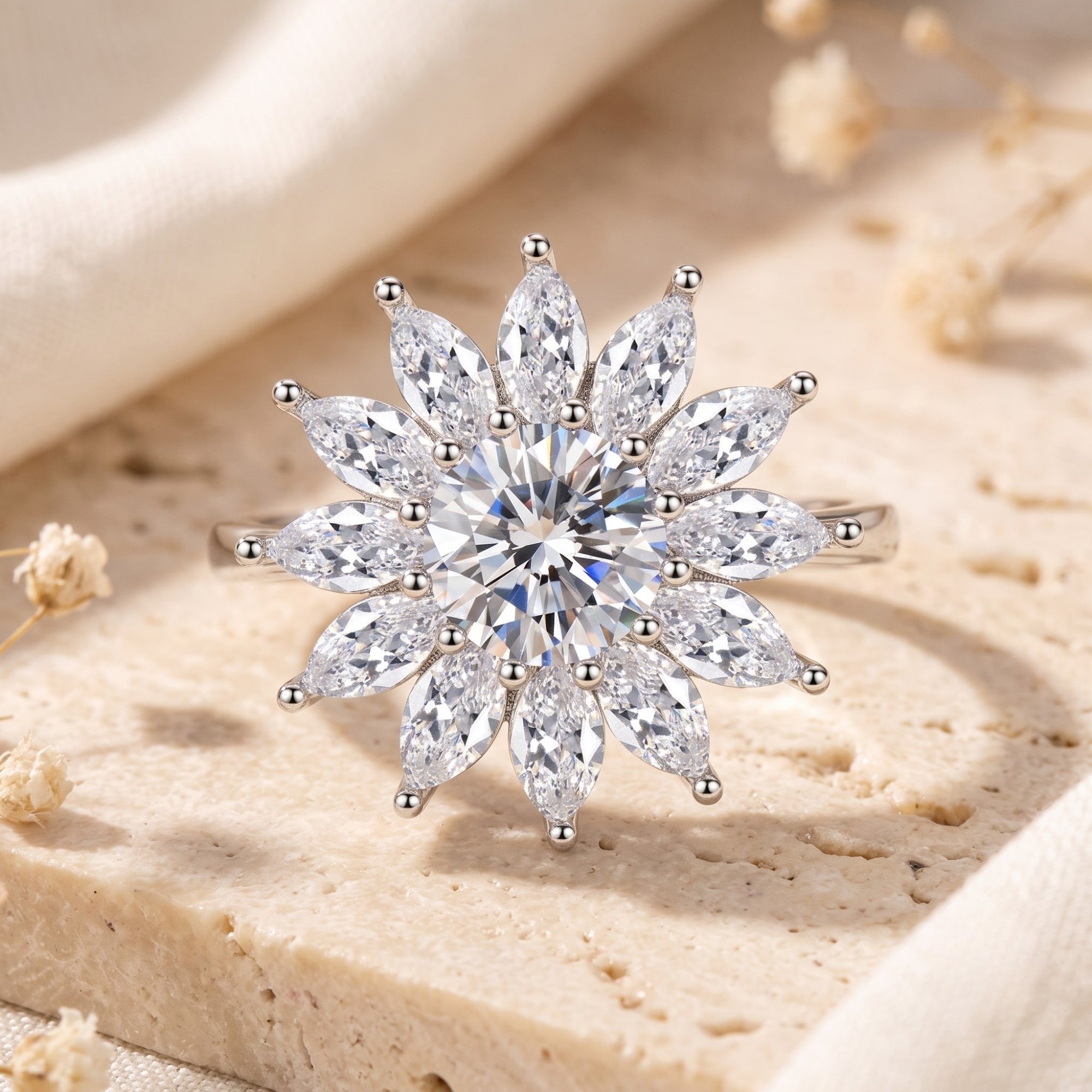 Macro view of a silver floral starburst ring with a round brilliant center and marquise-cut halo stones.