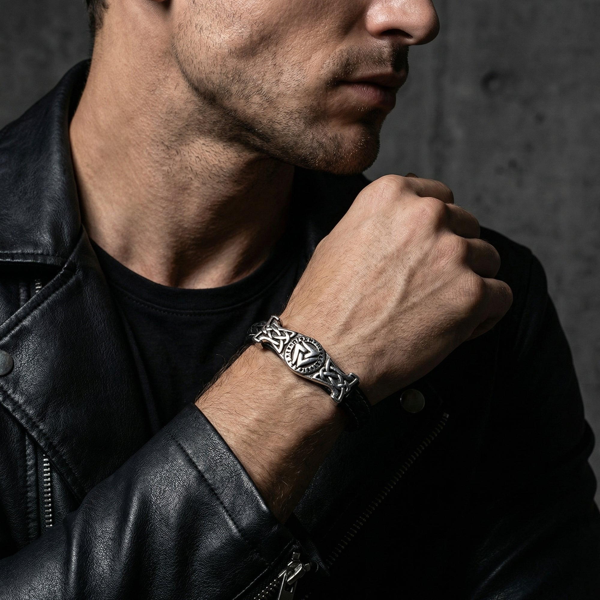 Men's Runeknot bracelet in black leather and stainless steel styled with a black leather jacket.