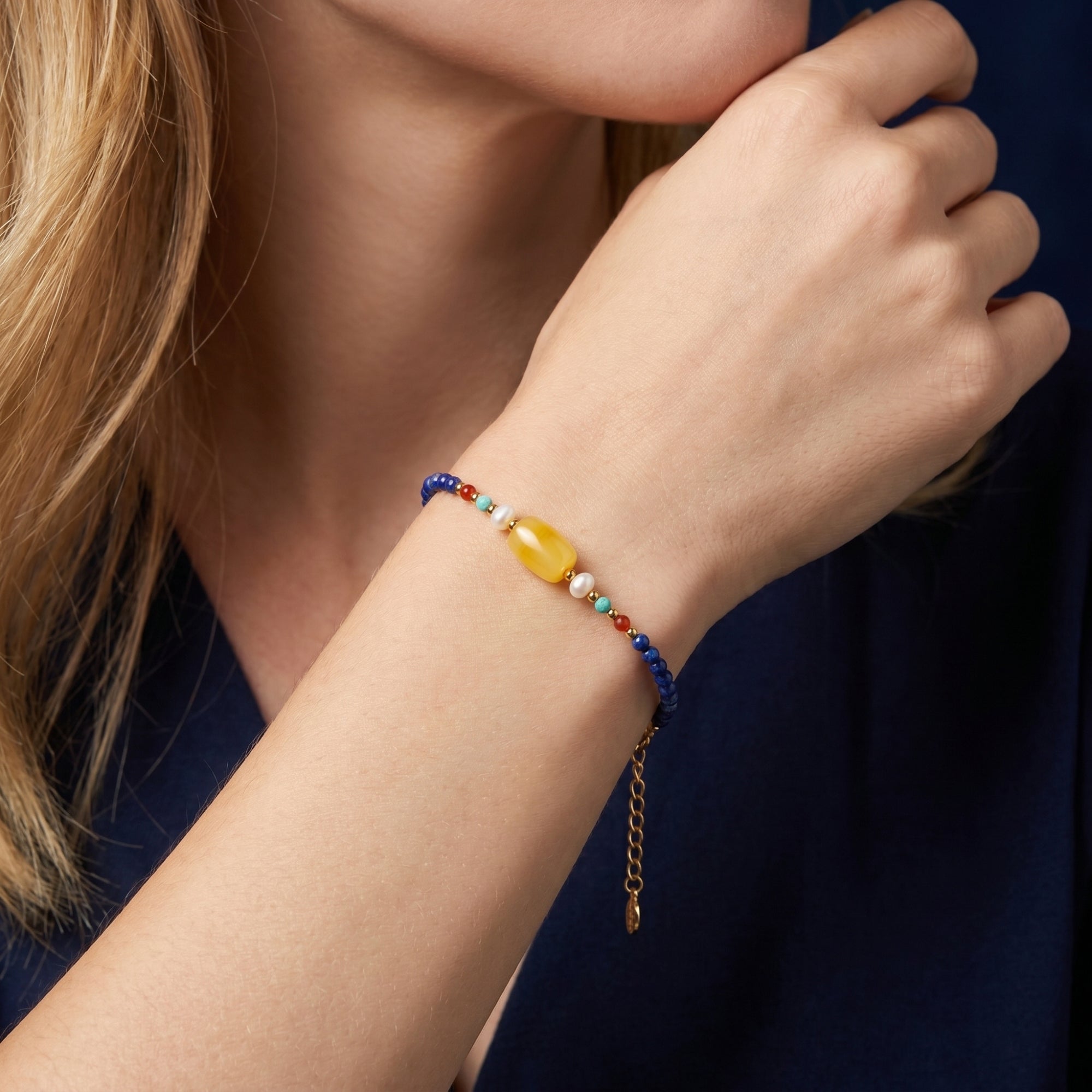 Side view of the Azure Melody lapis lazuli and gold-plated bracelet worn on a model's wrist.