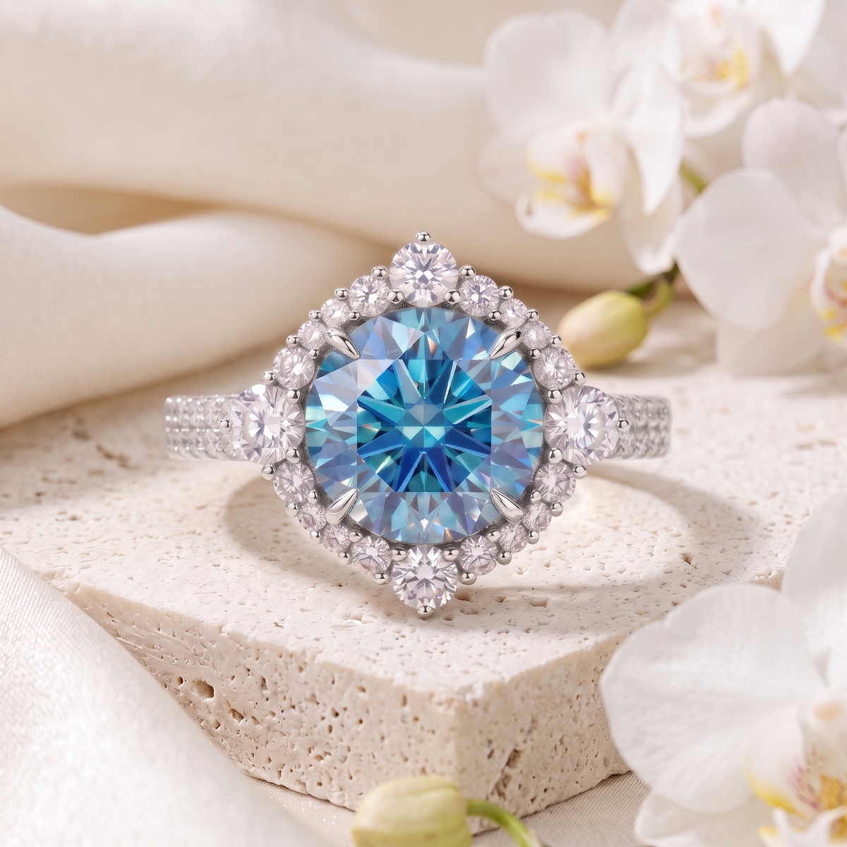 Round blue moissanite engagement ring with geometric diamond halo in white gold on travertine stone