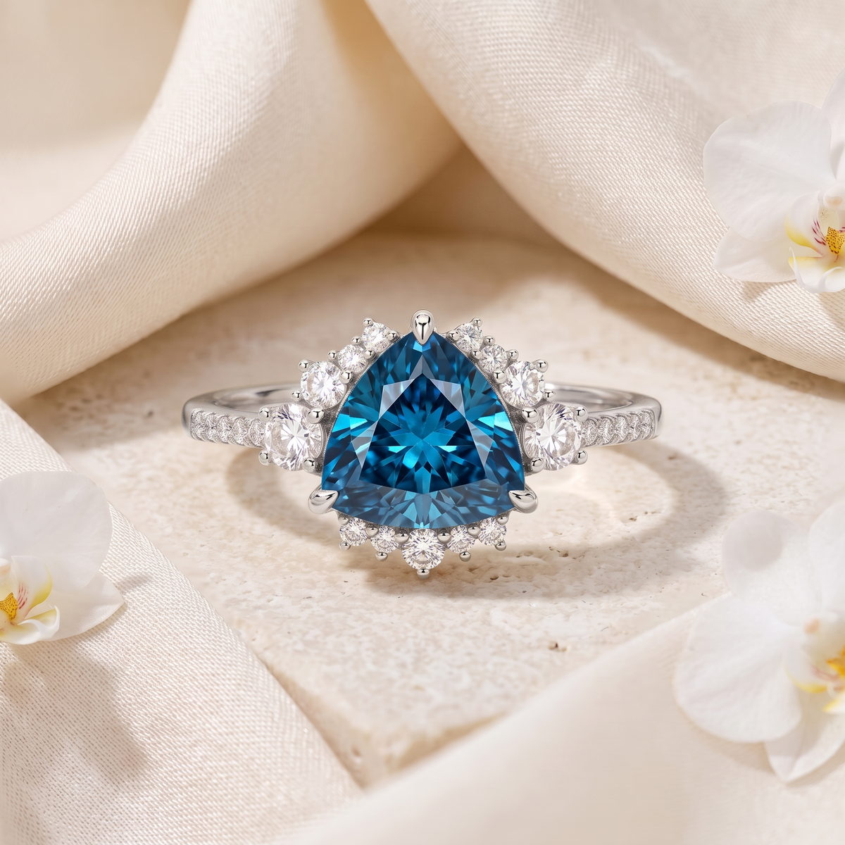 Front view of a trillion-cut blue moissanite halo ring in white gold.