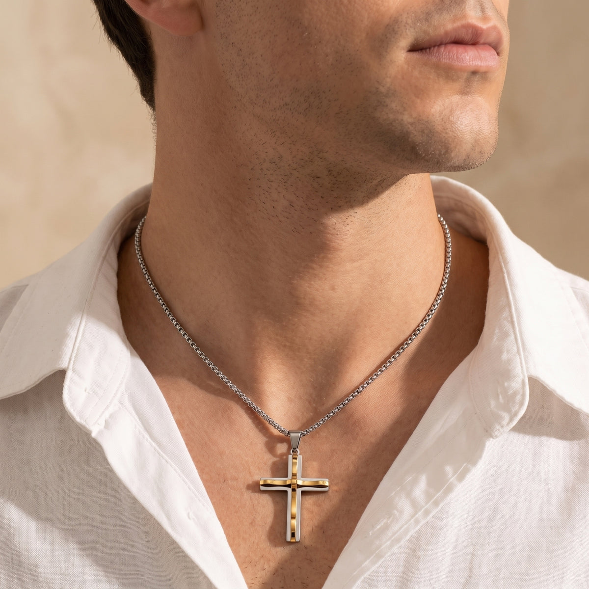 Model wearing the two-tone layered cross necklace with an open-collar white button-down shirt.