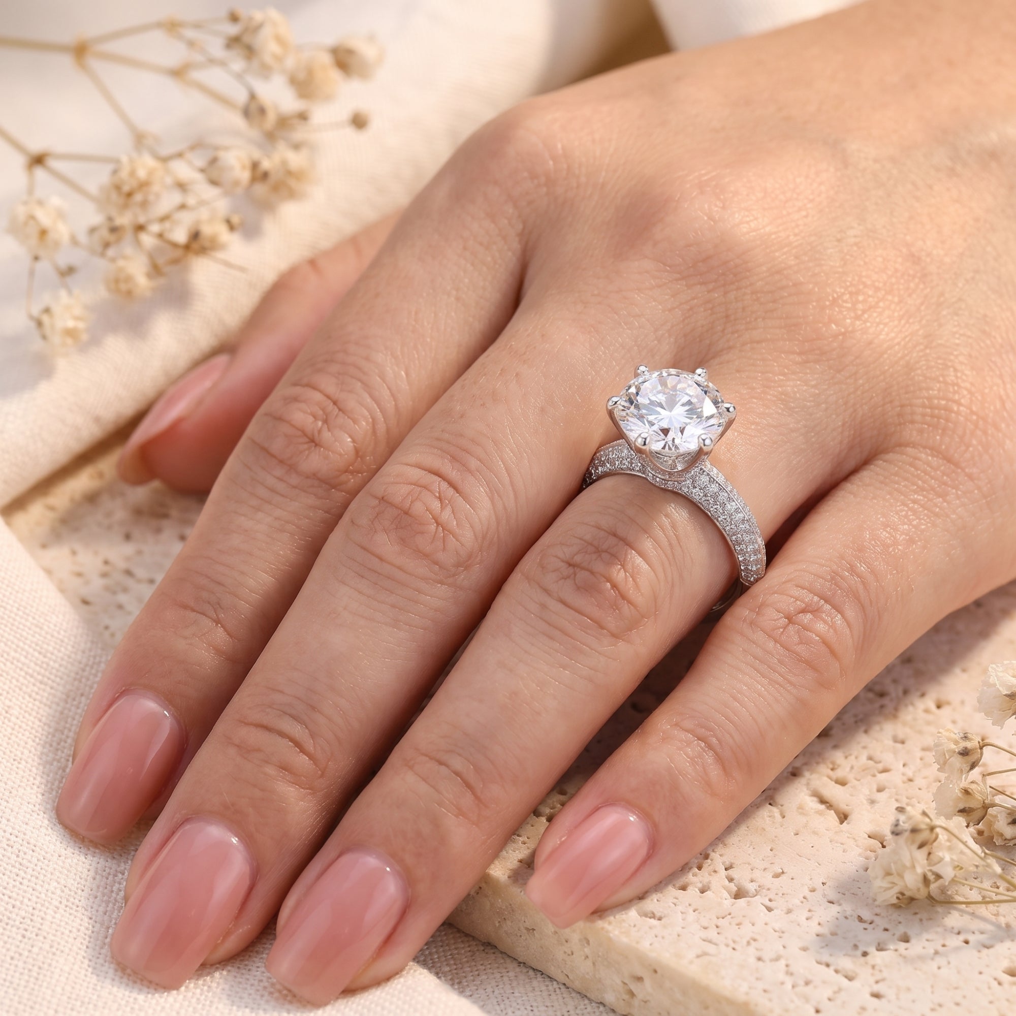 Angled view of the 11mm sterling silver solitaire ring on a finger, highlighting the center stone.