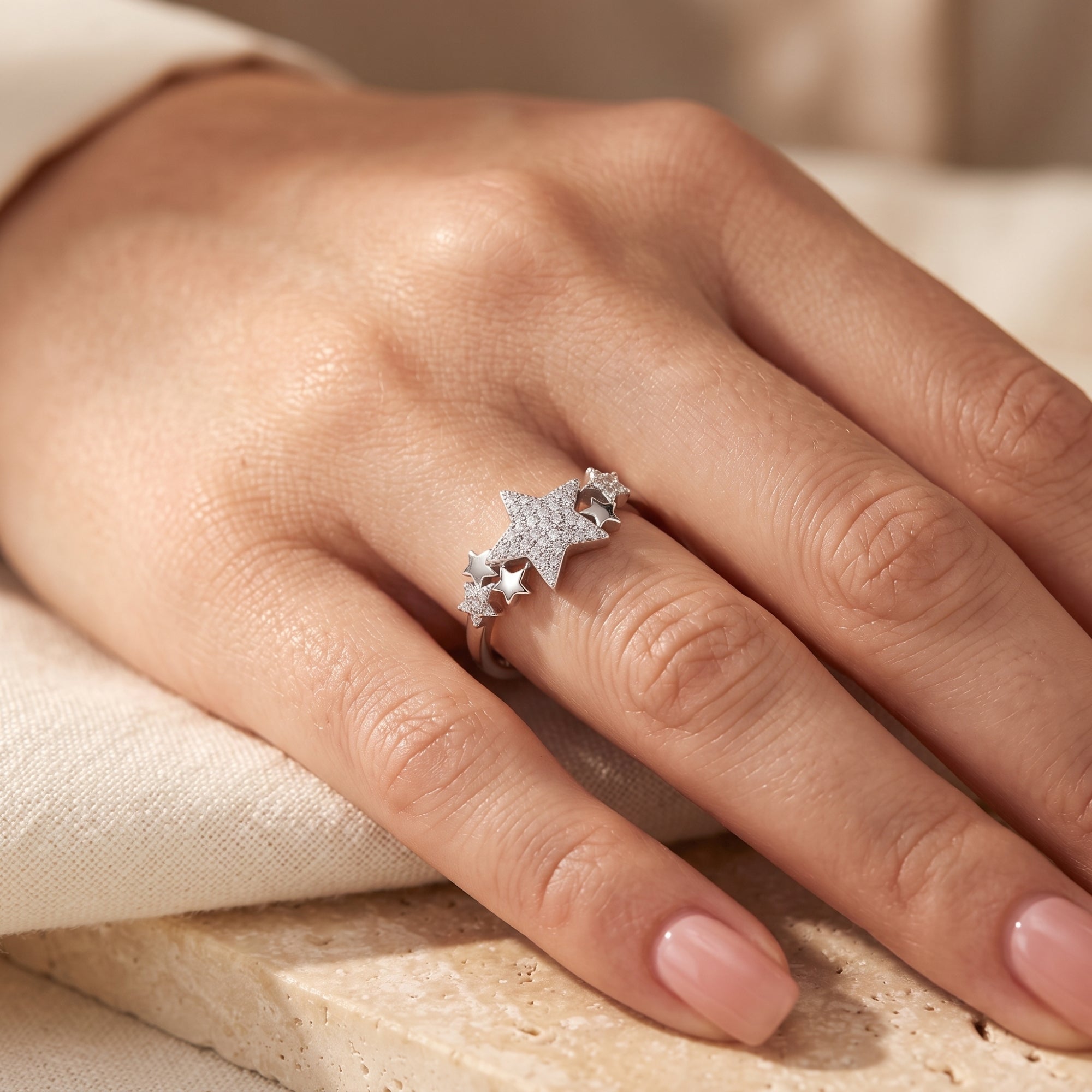 Celestia star cluster ring in sterling silver with simulated diamonds shown on a model's finger.
