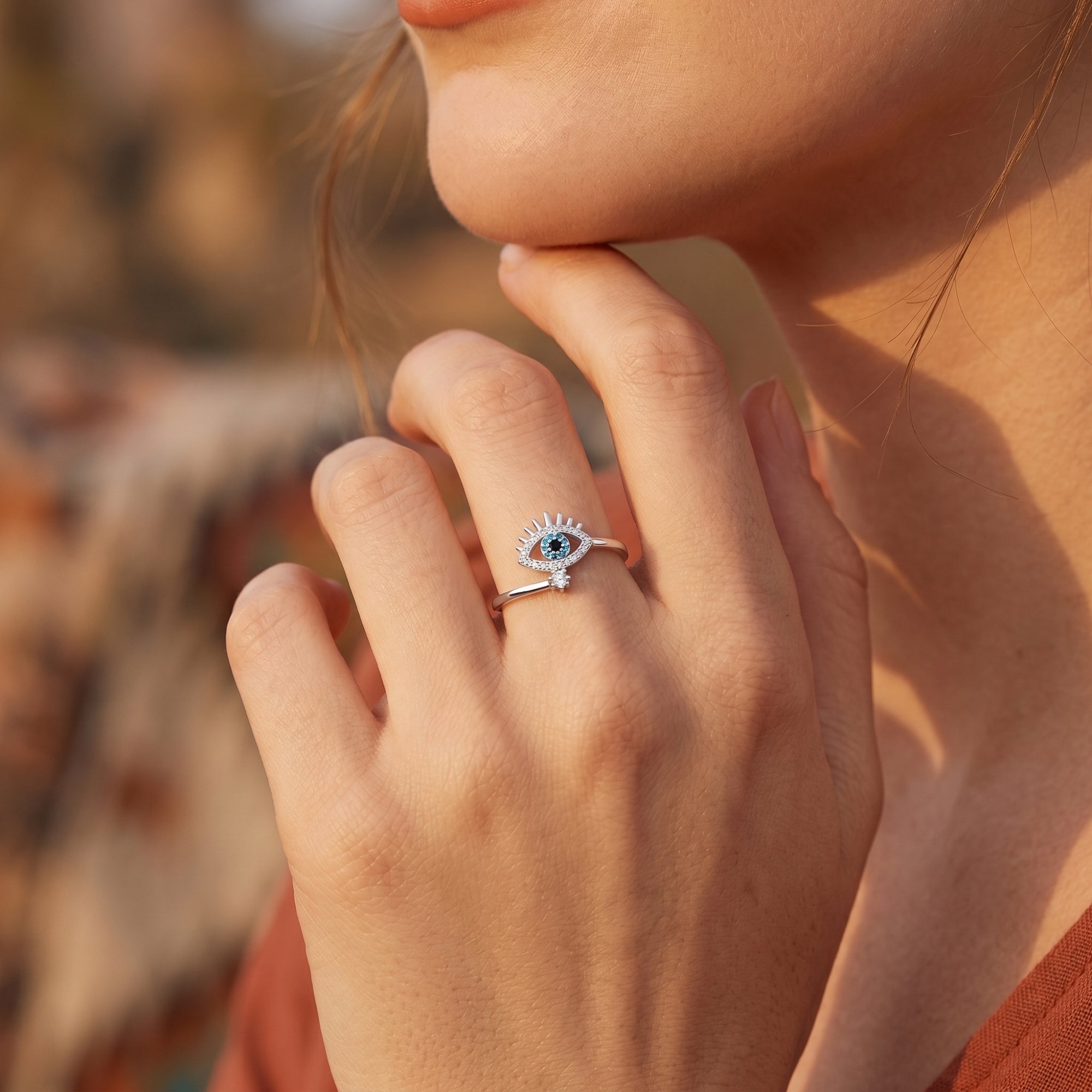 Model wearing the silver Amaya turquoise ring, showcasing the evil eye talisman design on her finger.