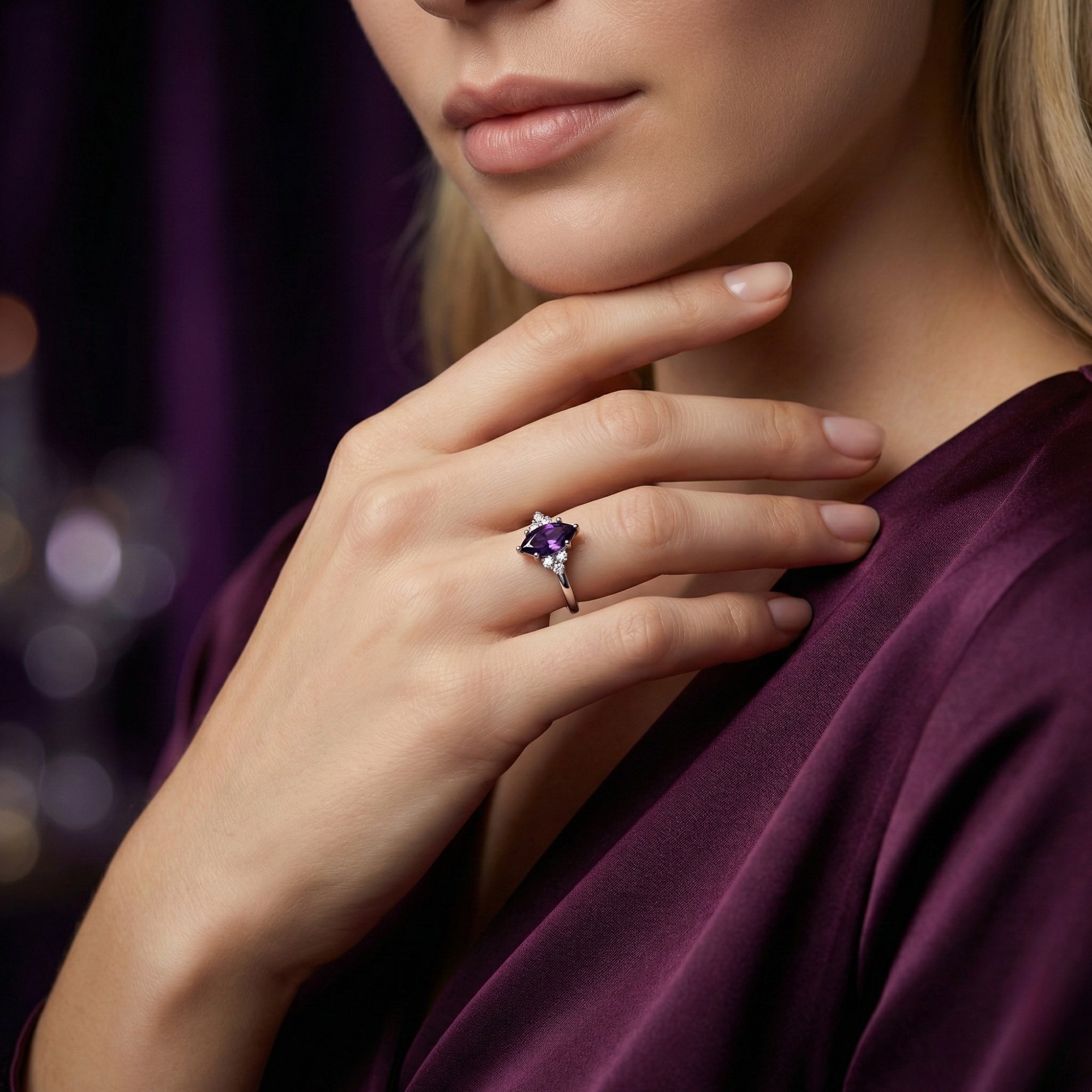 Marquesa cut amethyst gemstone ring in sterling silver worn by a model in a purple dress.