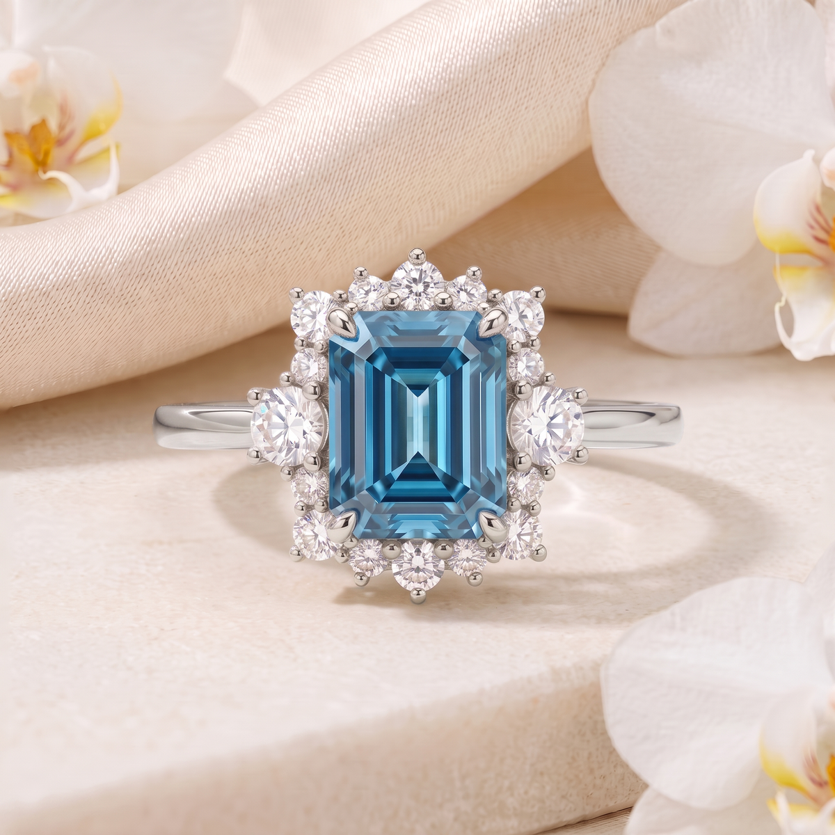 Front view of an emerald-cut blue moissanite halo ring in white gold.