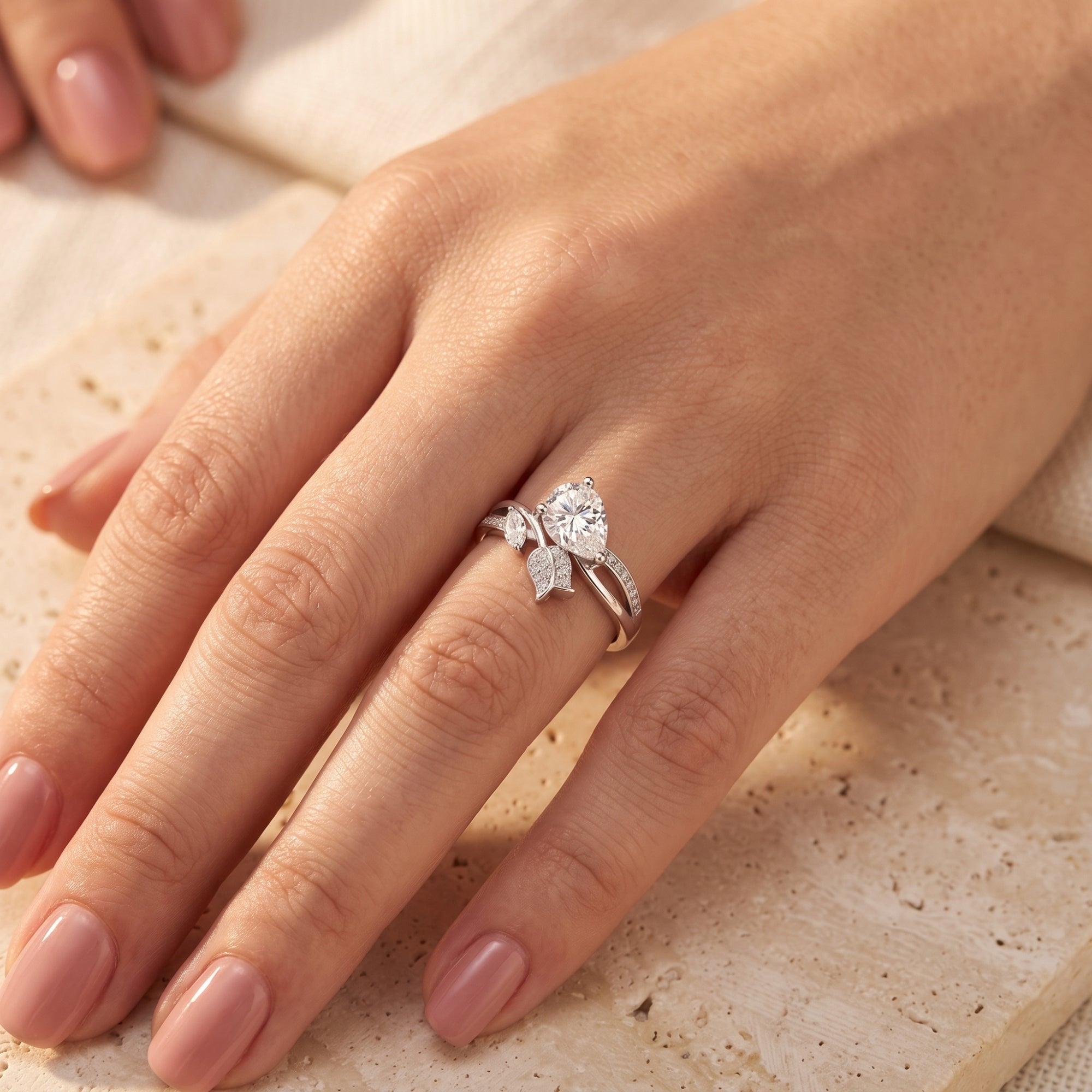 S925 sterling silver willow leaf promise ring with pear-cut simulated diamond shown on a finger.