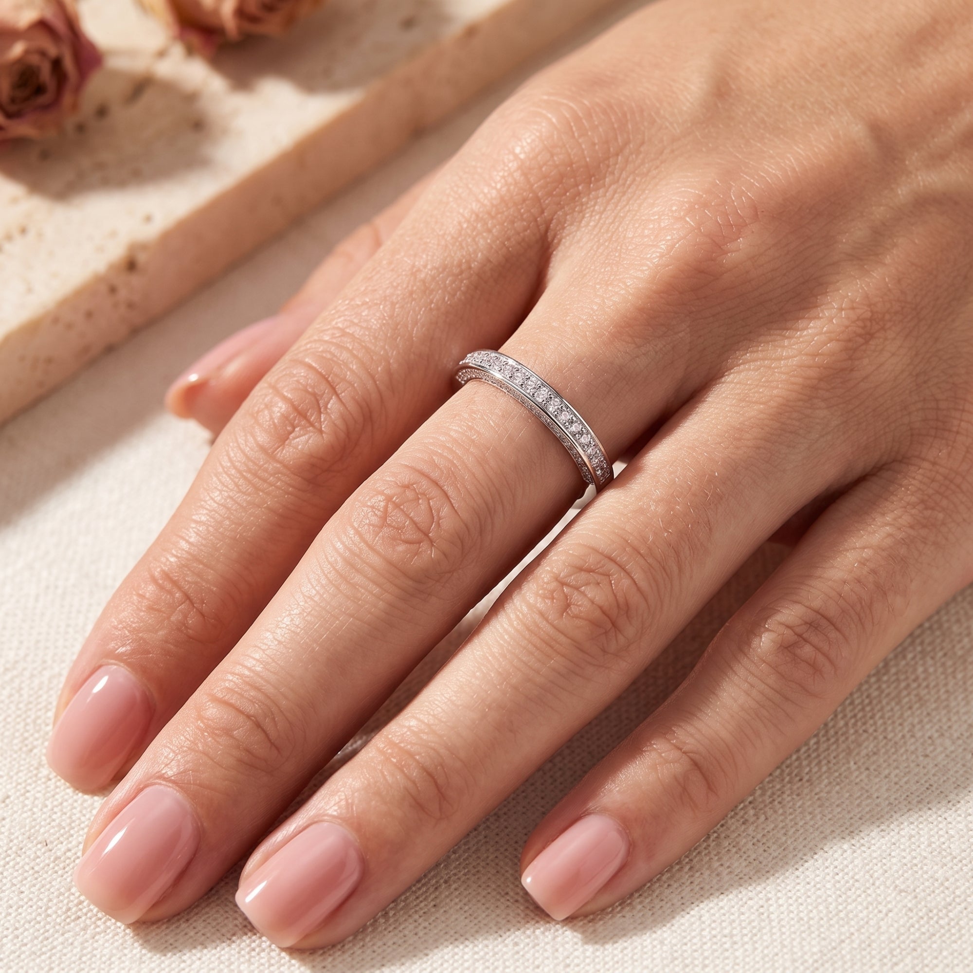 Sterling silver double row pavé ring shown on a hand for scale.