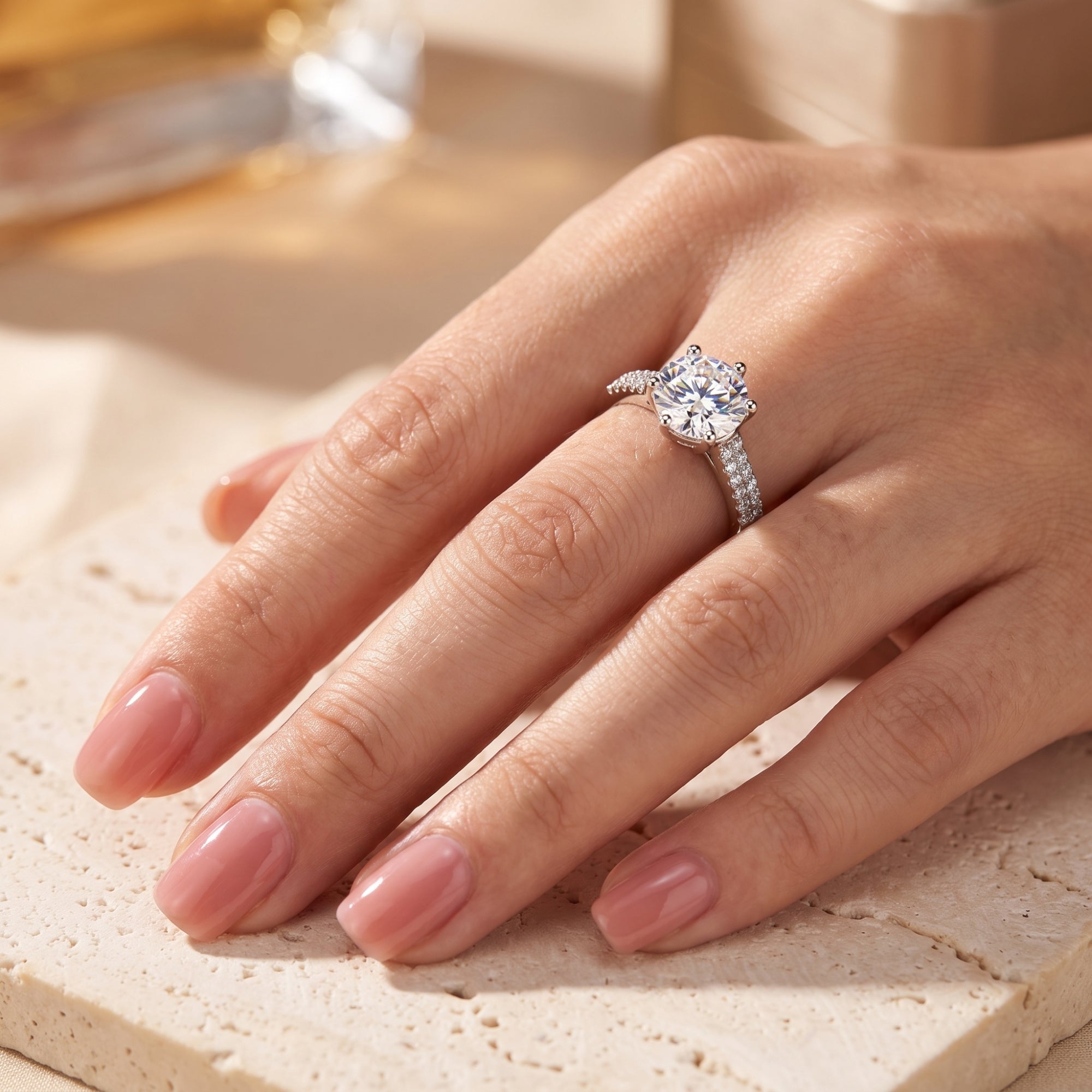 Round-cut simulated diamond sterling silver ring shown on a model's finger.