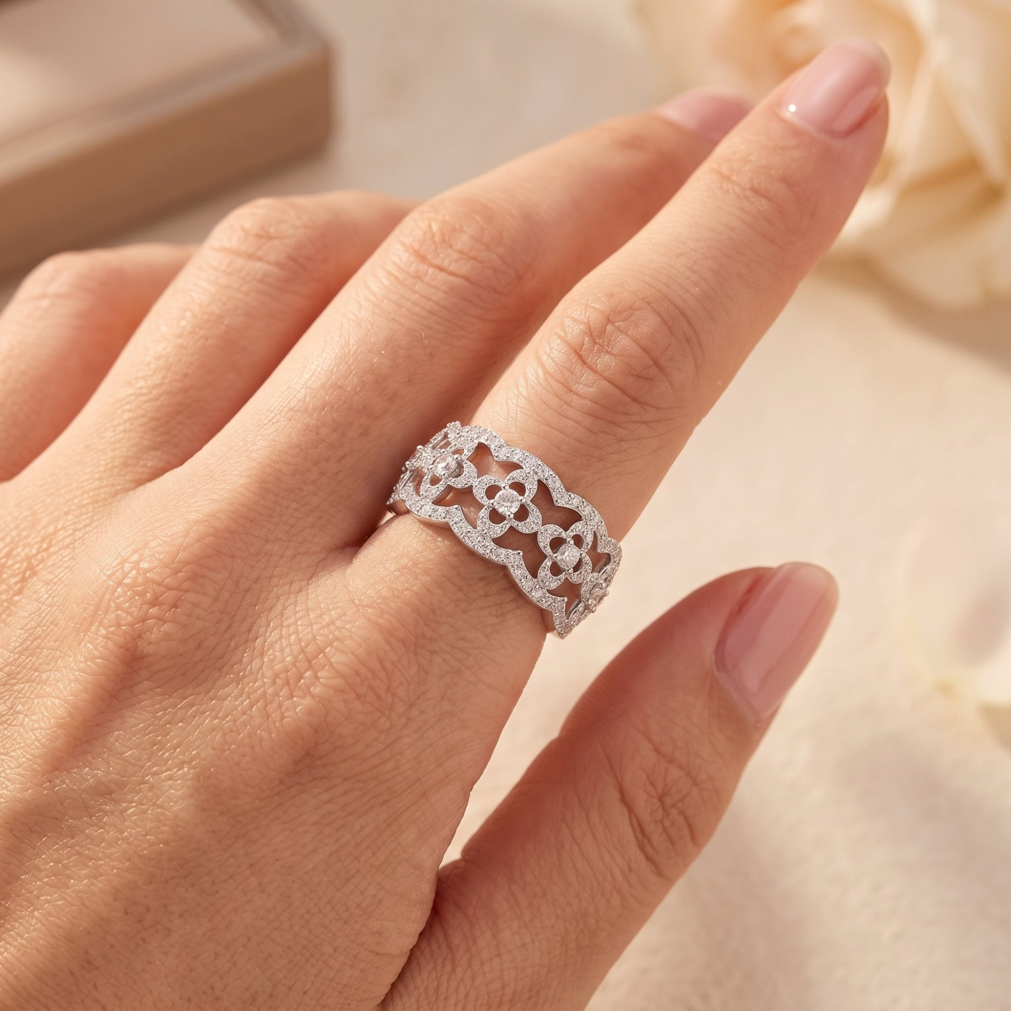 S925 sterling silver clover lattice ring with simulated diamonds shown on a finger for scale.