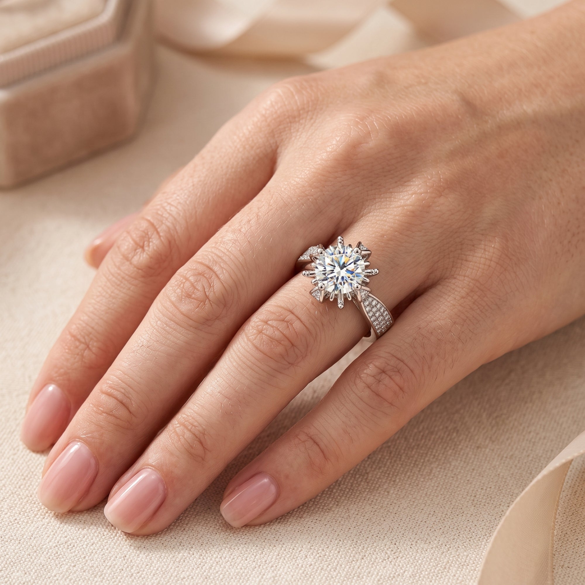S925 sterling silver starburst solitaire ring with a 6.5mm cubic zirconia center stone on a finger.