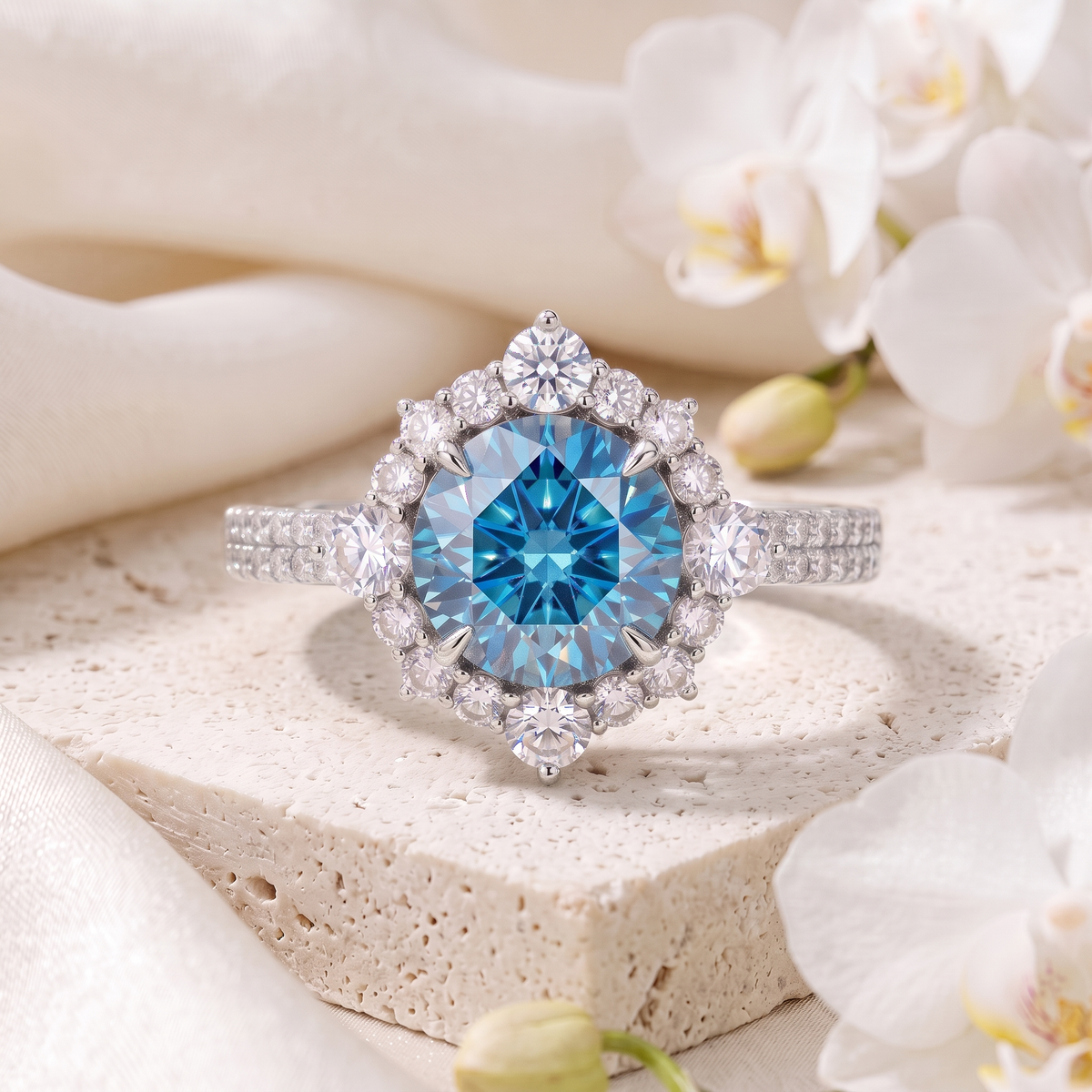 White gold round blue moissanite halo ring displayed on a natural stone block.