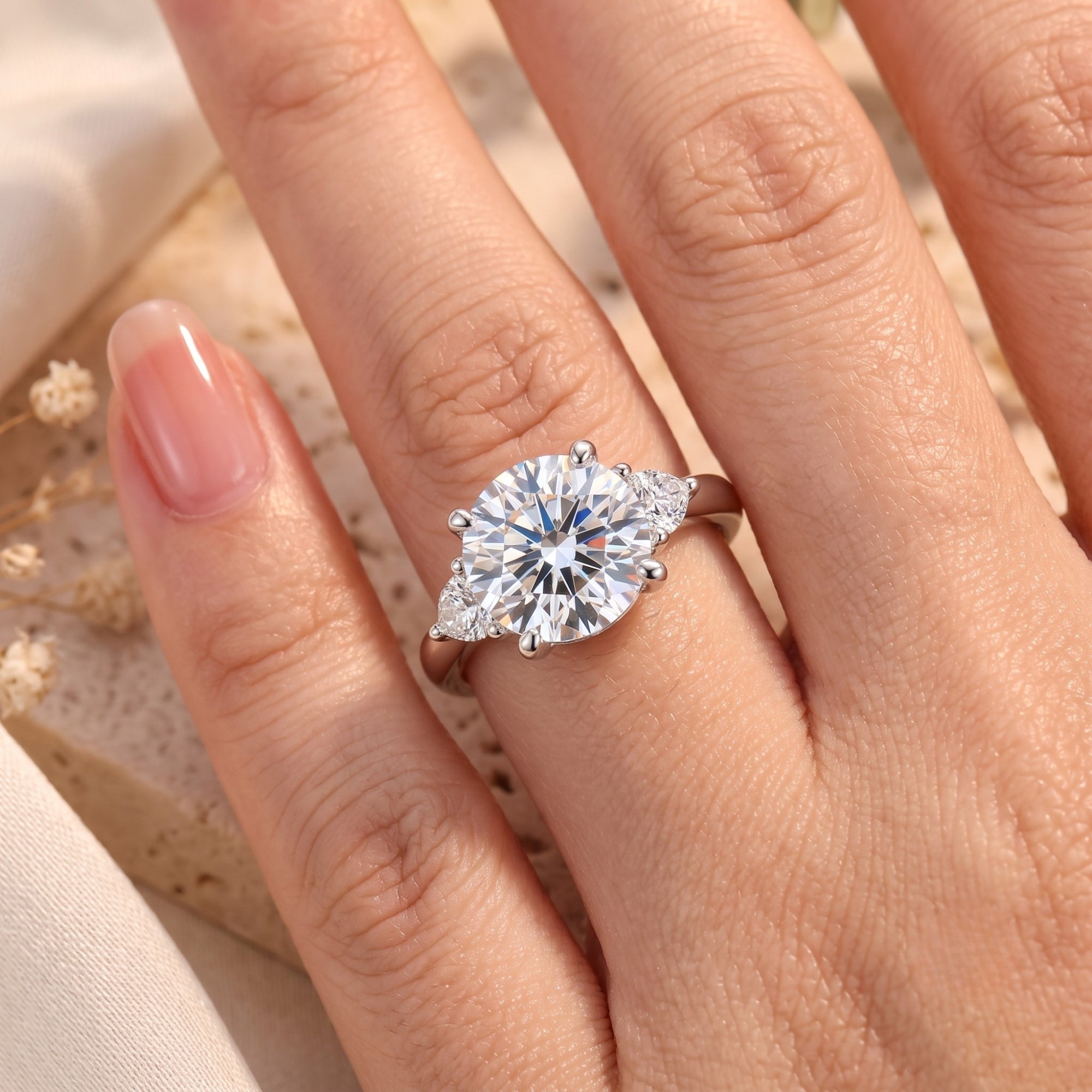 Close-up of round-cut cubic zirconia promise ring on a hand.