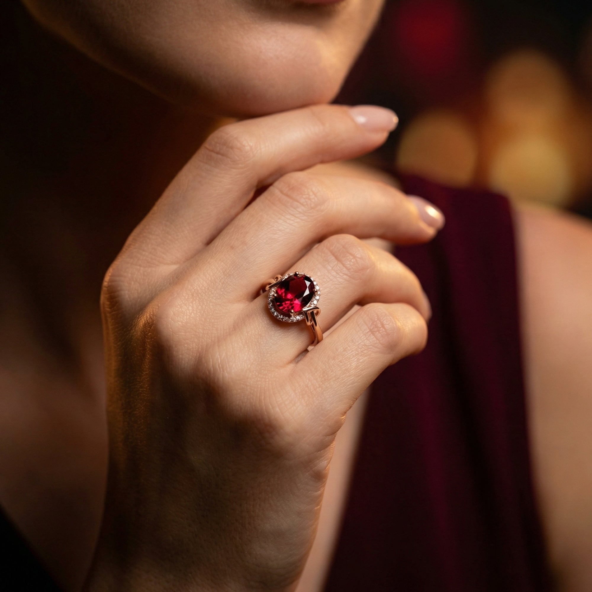 Model wearing the 18K rose gold Cerelia ring with an oval garnet centerpiece, highlighting its elegant fit.