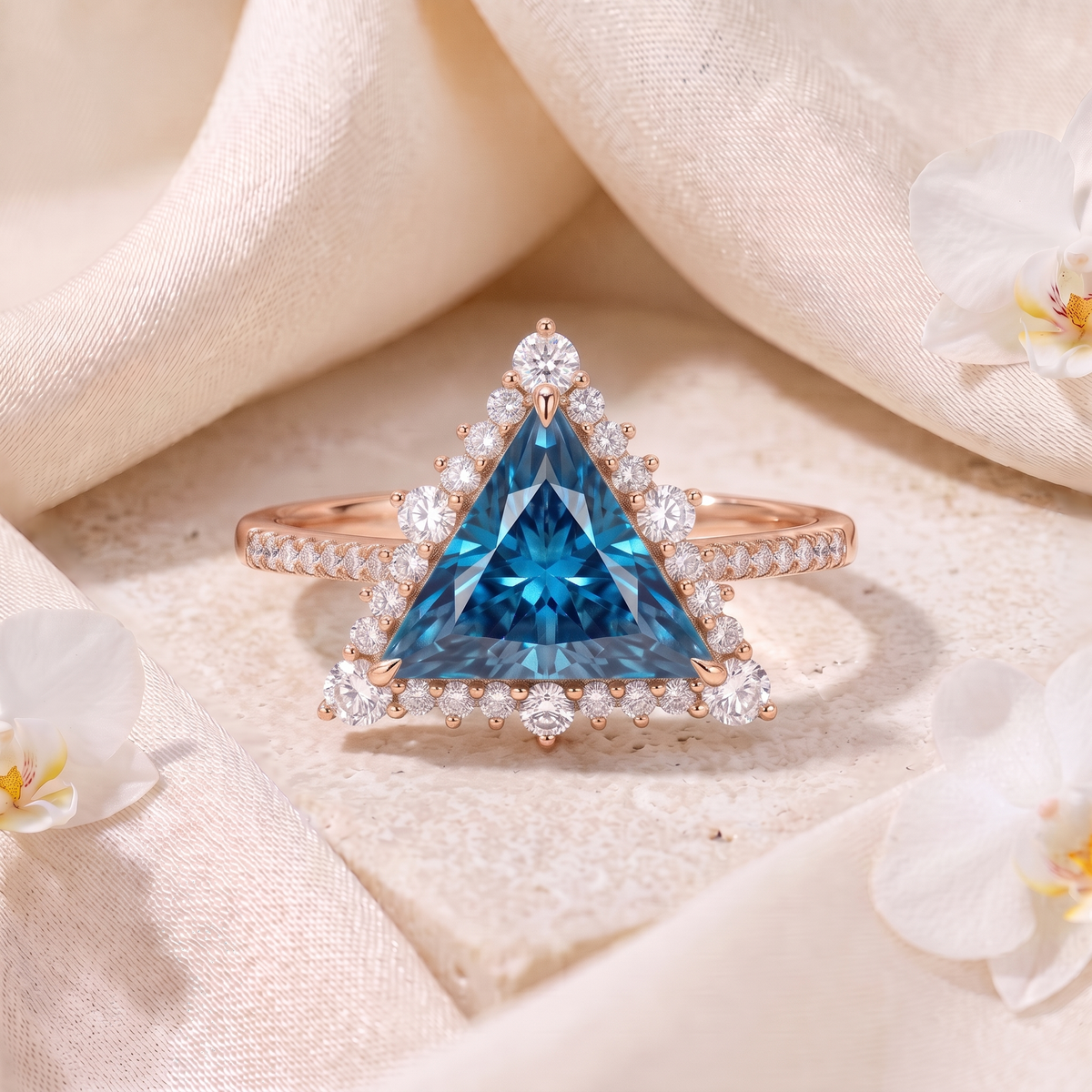 Rose gold trillion-cut blue moissanite engagement ring with diamond halo and pavé band