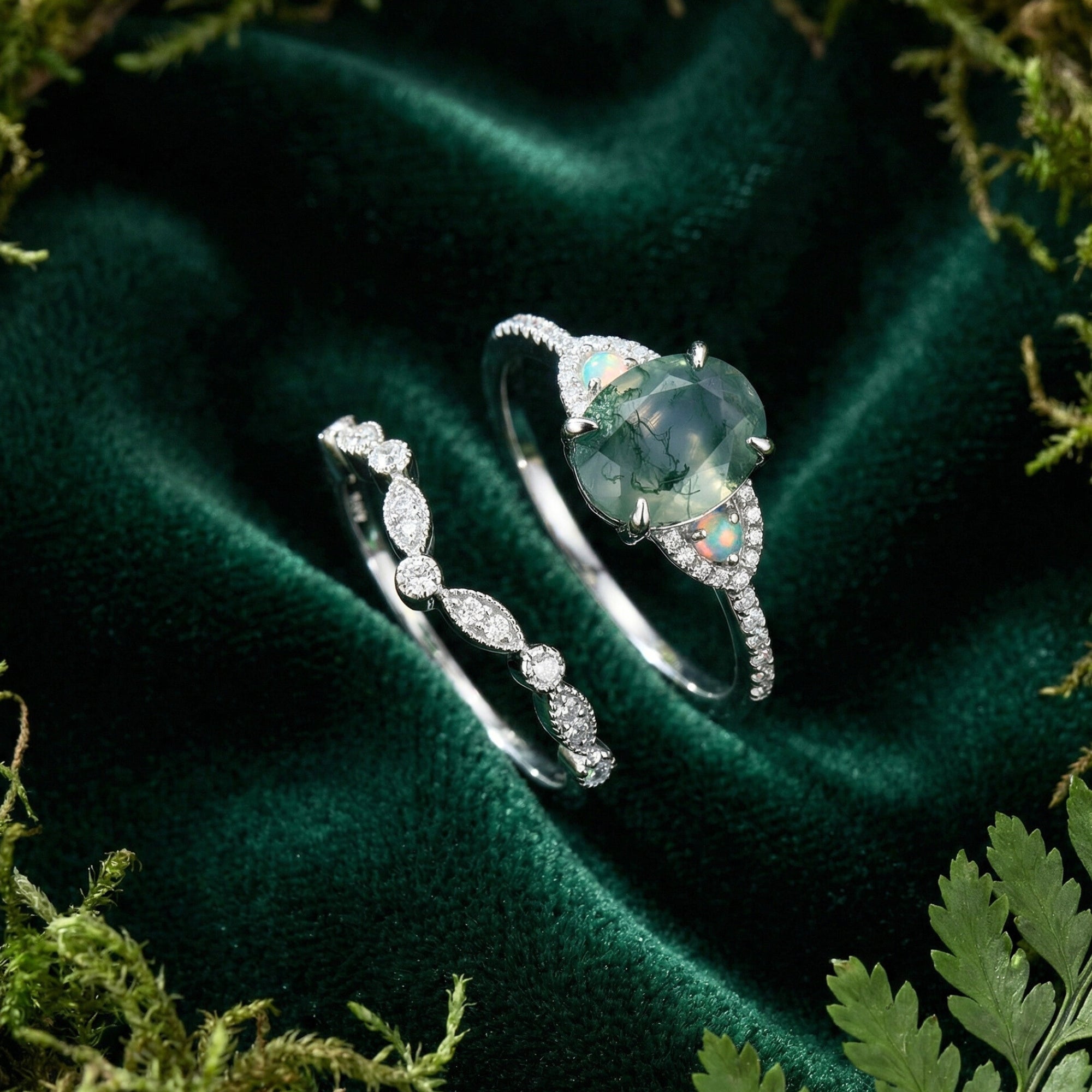 Sterling silver oval moss agate engagement ring and curved diamond band shown separately on green velvet.