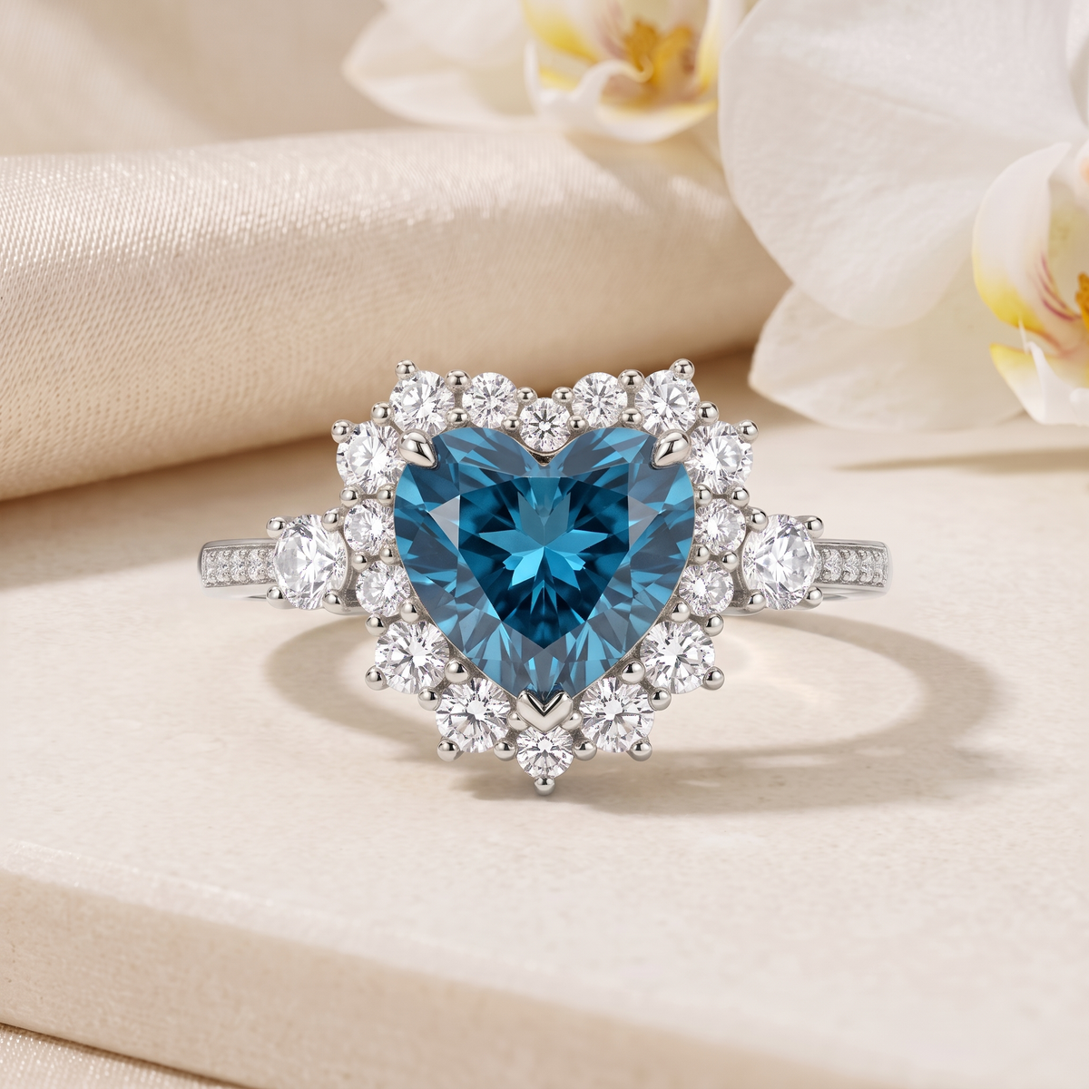 Front view of a heart-shaped blue moissanite halo ring in white gold.