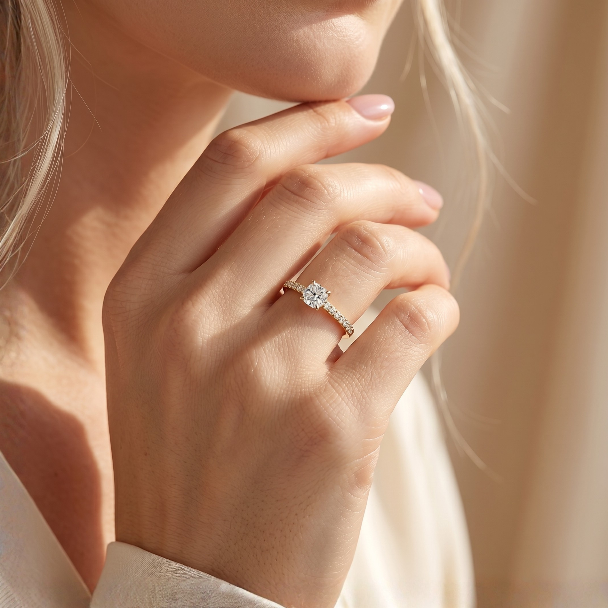 A close-up of a model wearing the yellow gold cushion-cut moissanite ring.