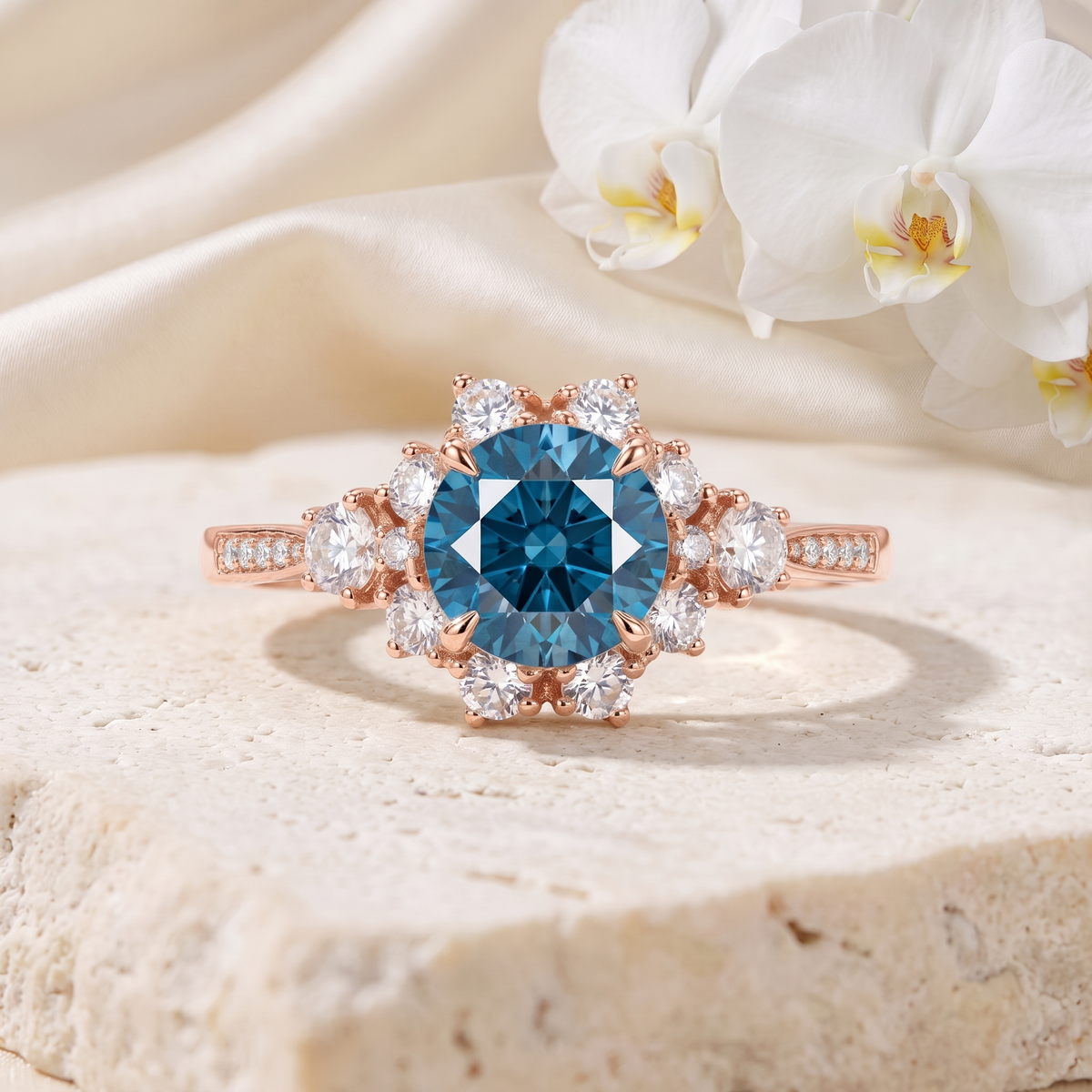 Rose gold halo engagement ring featuring a round blue moissanite center stone with a floral cluster halo.