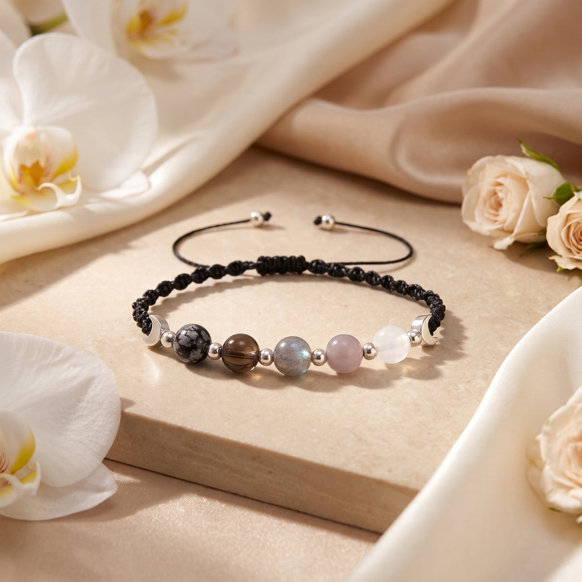 Black adjustable-cord moon-phase bracelet with silver-tone crescent accents and five contrasting beads