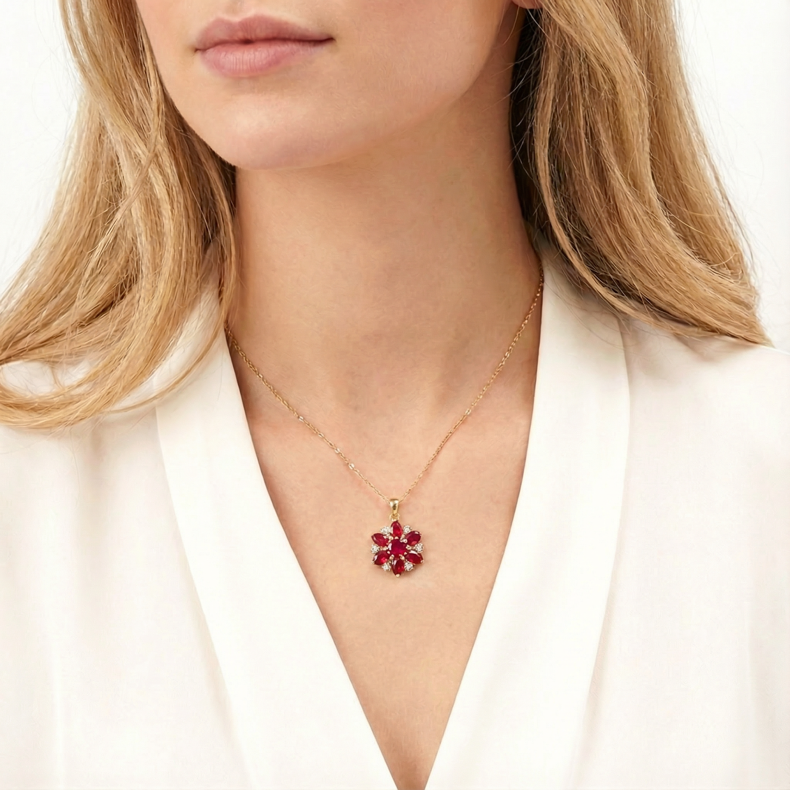 July birthstone simulated ruby blossom necklace in gold-finished stainless steel worn by a model.