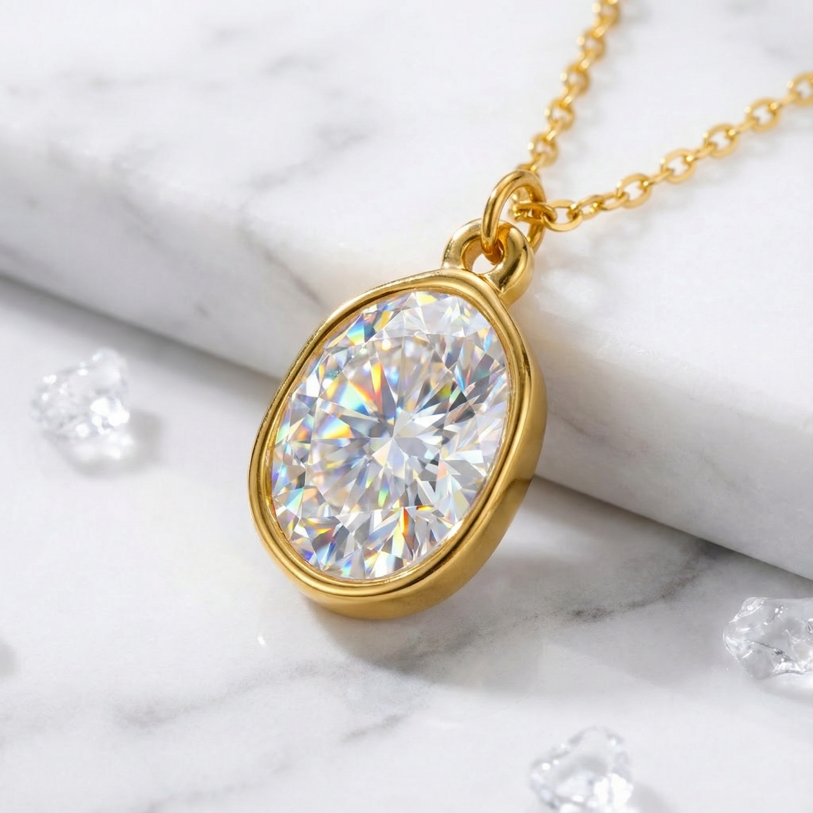 Macro view of the pear-cut zirconia stone and gold-finished stainless steel bezel setting on the Kyrielle necklace.