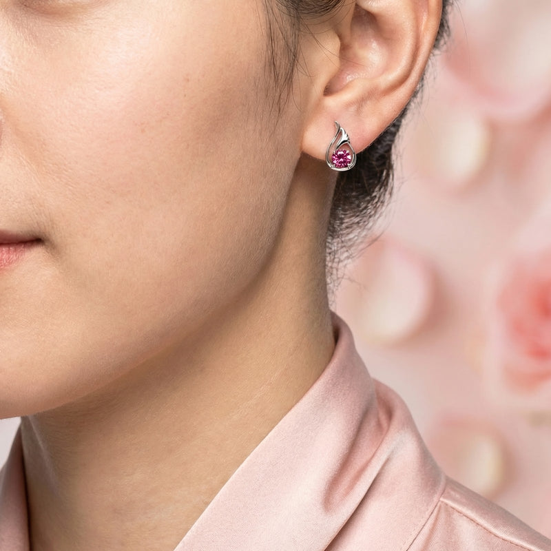 Profile view of a model wearing a sterling silver Nerienne Bud earring with a round simulated pink tourmaline.