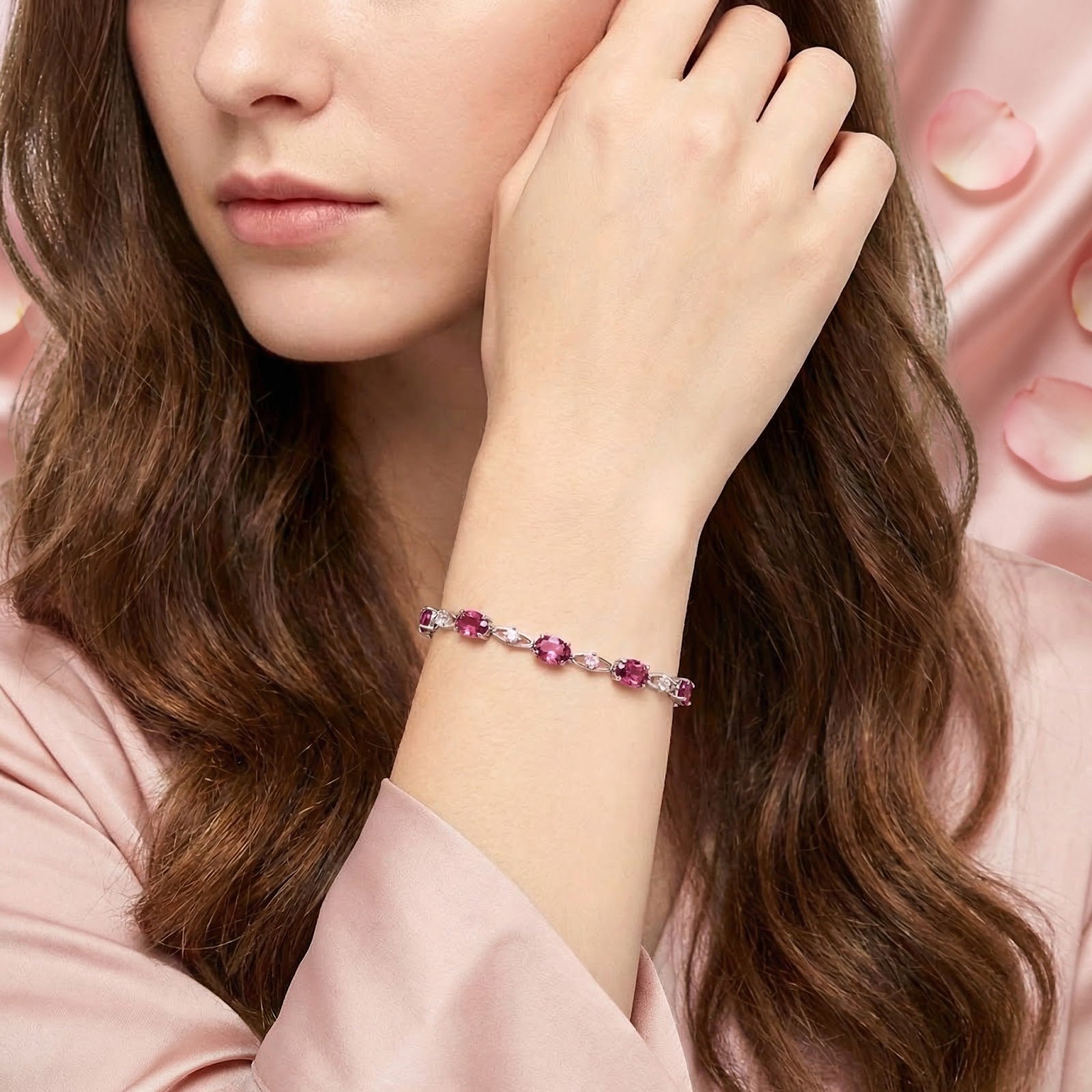 Model wearing the Nerisara leaf bracelet with pink tourmaline stones in sterling silver on her wrist.