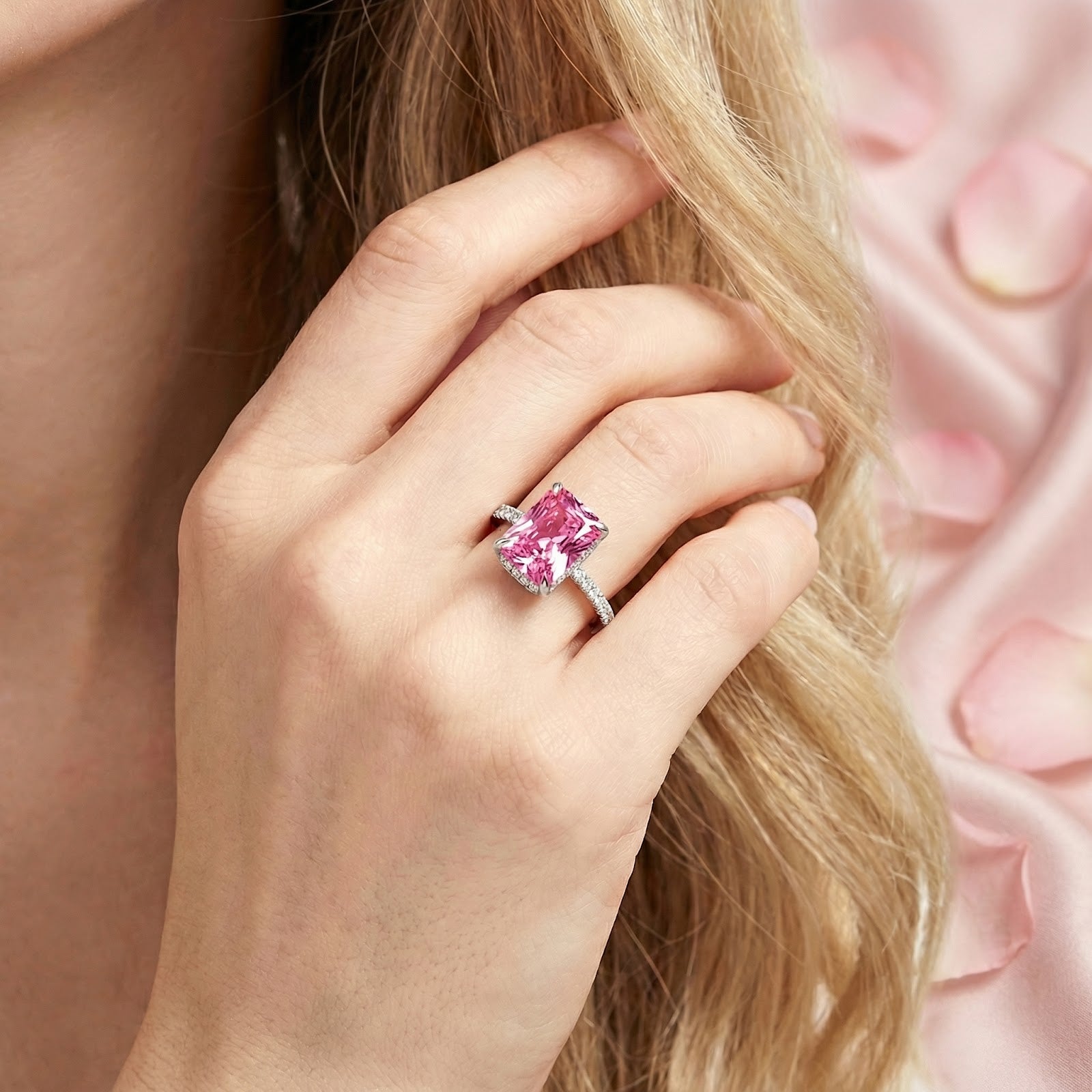 Radiant cut pink tourmaline sterling silver ring worn on a woman's hand.