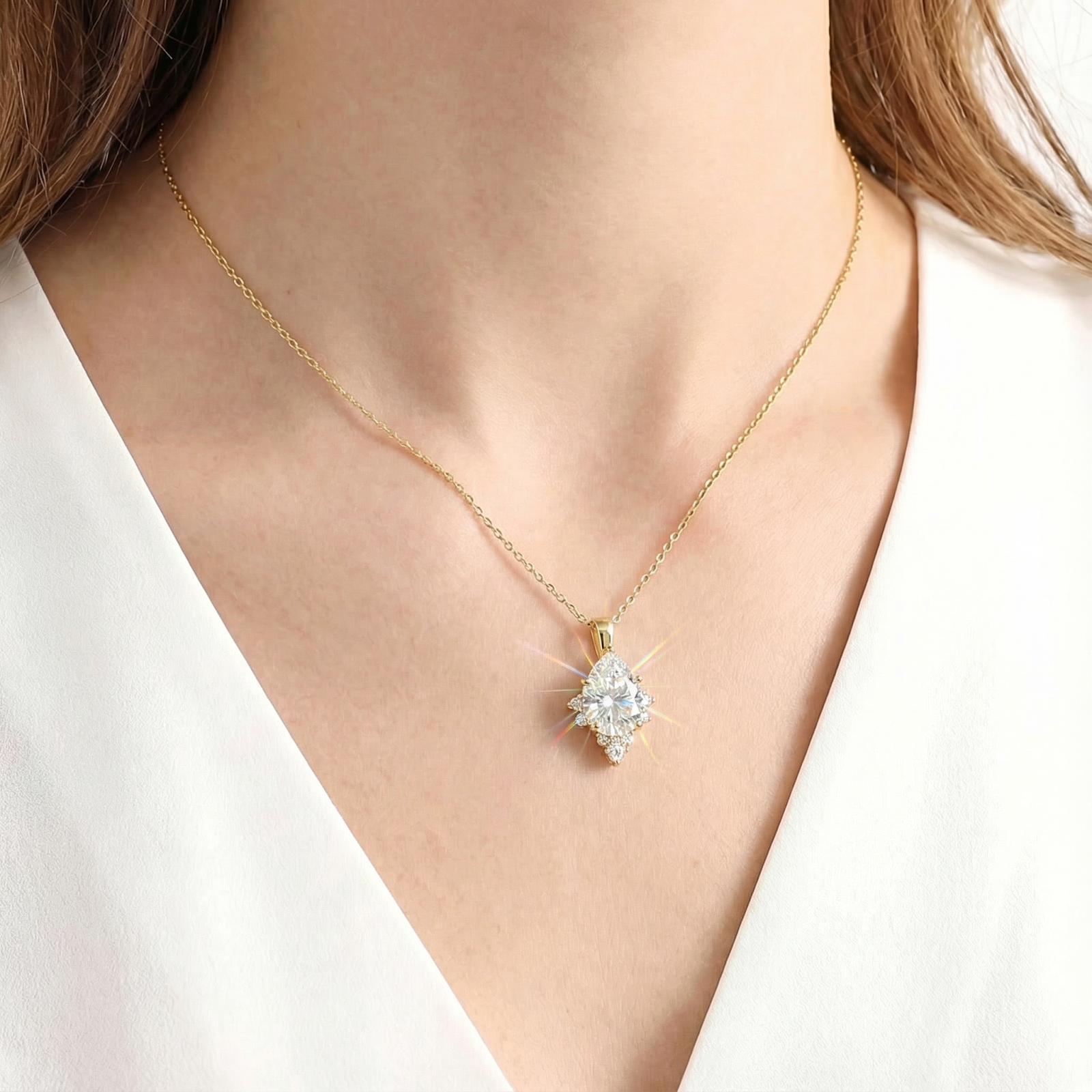April birthstone pear-cut zirconia necklace in 18K gold vermeil worn on a woman's neck.