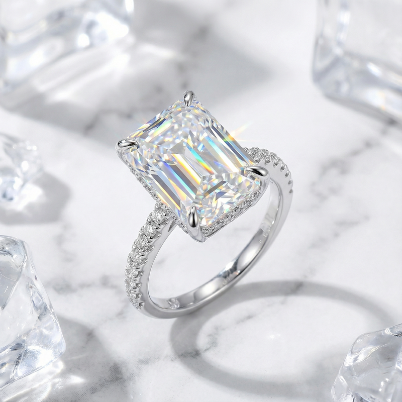 Angled view of the Hespera radiant cut simulated diamond ring in sterling silver with a pavé band.