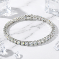 Aris round zirconia tennis bracelet in silver stainless steel on a marble surface with decorative ice cubes.