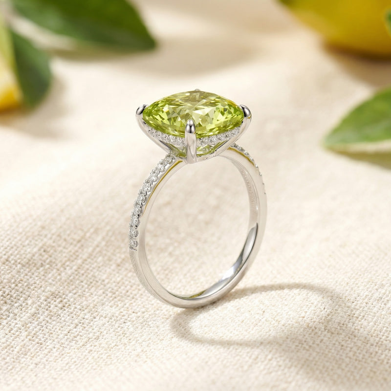 Side view of the cushion-cut simulated peridot ring in S925 sterling silver showing the elevated pave setting.