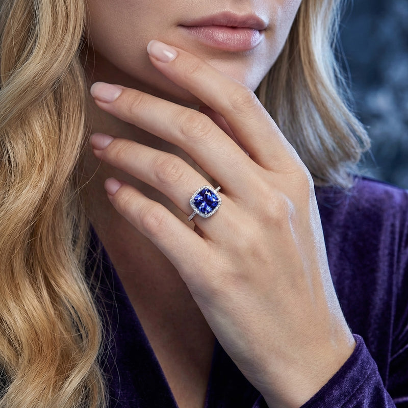 Woman wearing the cushion cut simulated tanzanite sterling silver ring on her finger.