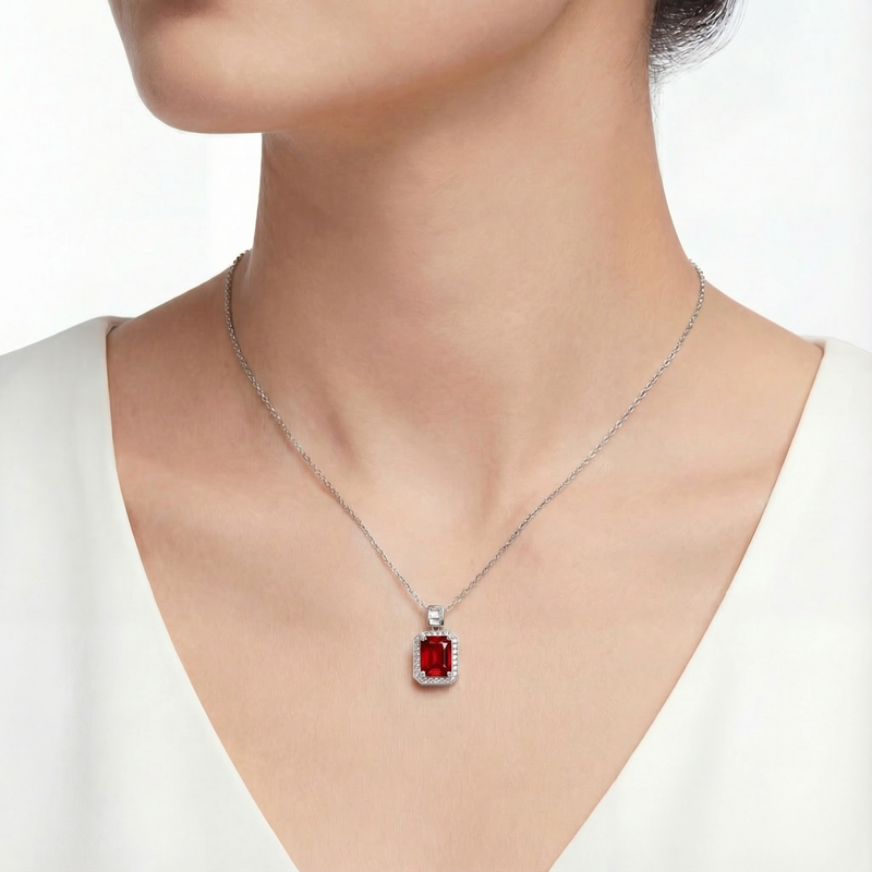 Model wearing the Aurelise emerald cut simulated ruby necklace in S925 sterling silver.