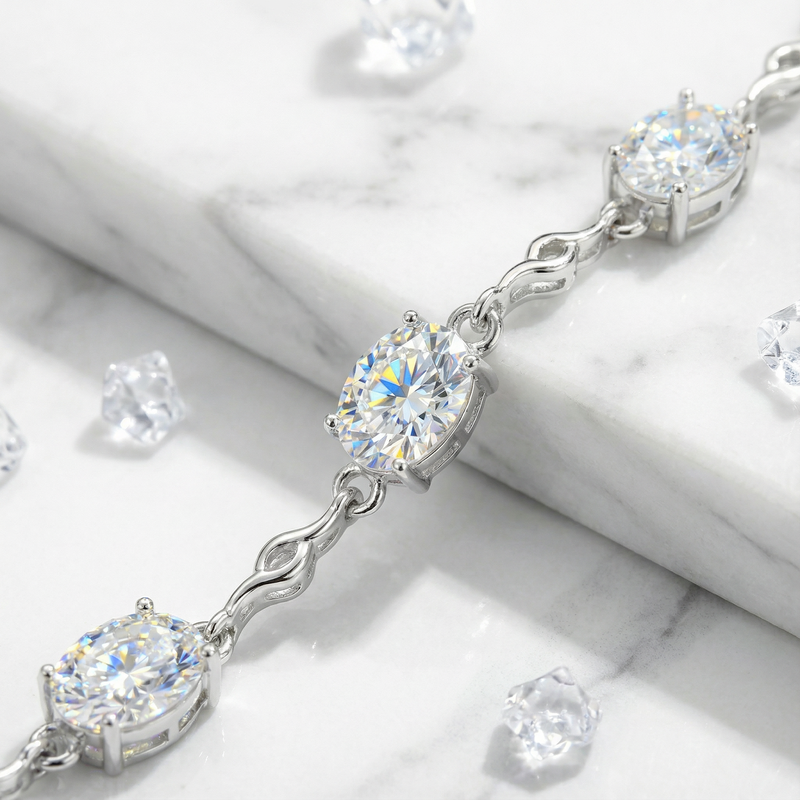 Close-up of oval-cut zirconia stones in a sterling silver station bracelet setting.