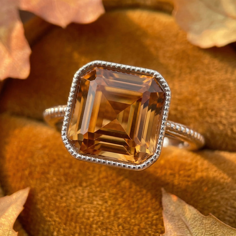 Macro shot of the cushion-cut honey gold simulated topaz and beaded S925 sterling silver bezel.