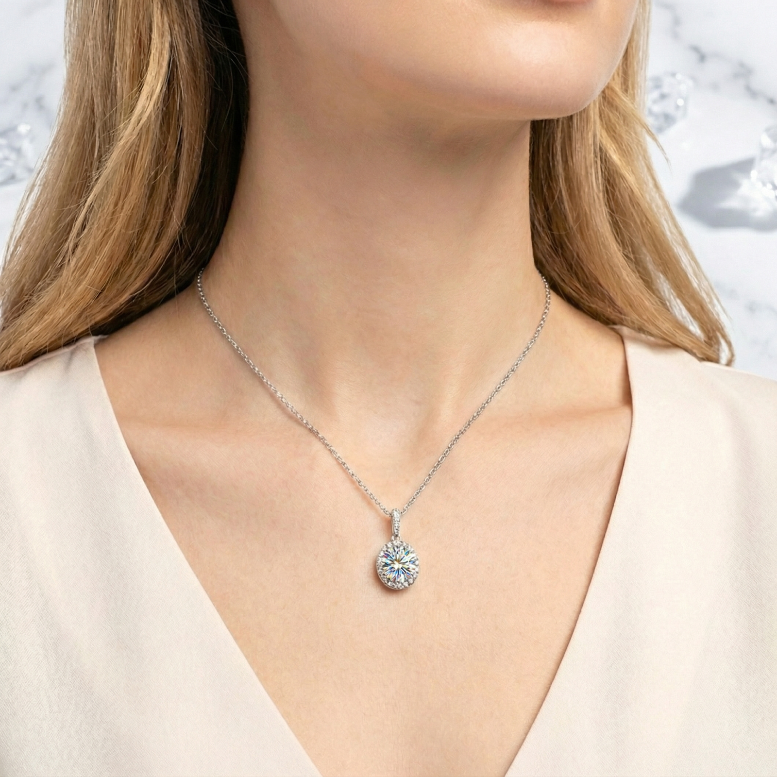 Front view of a model wearing the Elianthe oval halo simulated diamond necklace in sterling silver.