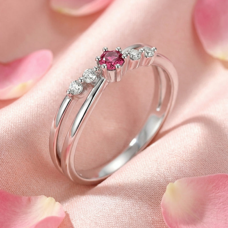 Angled macro view of the S925 sterling silver Elisanthe twist ring with a round-cut raspberry pink tourmaline.