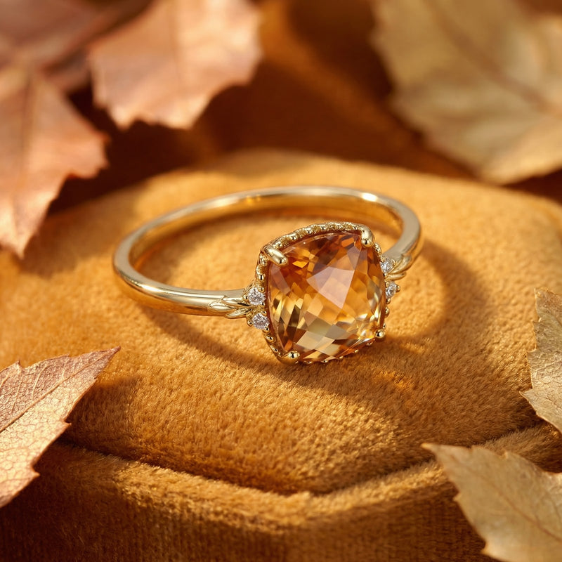 Macro detail of a cushion-cut simulated topaz stone in a decorative 18K gold vermeil ring setting.