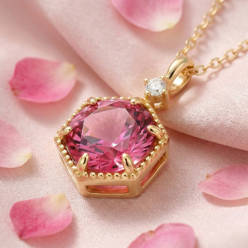 Angled detail of the hexagonal pink tourmaline necklace in 18K gold vermeil showing the setting.