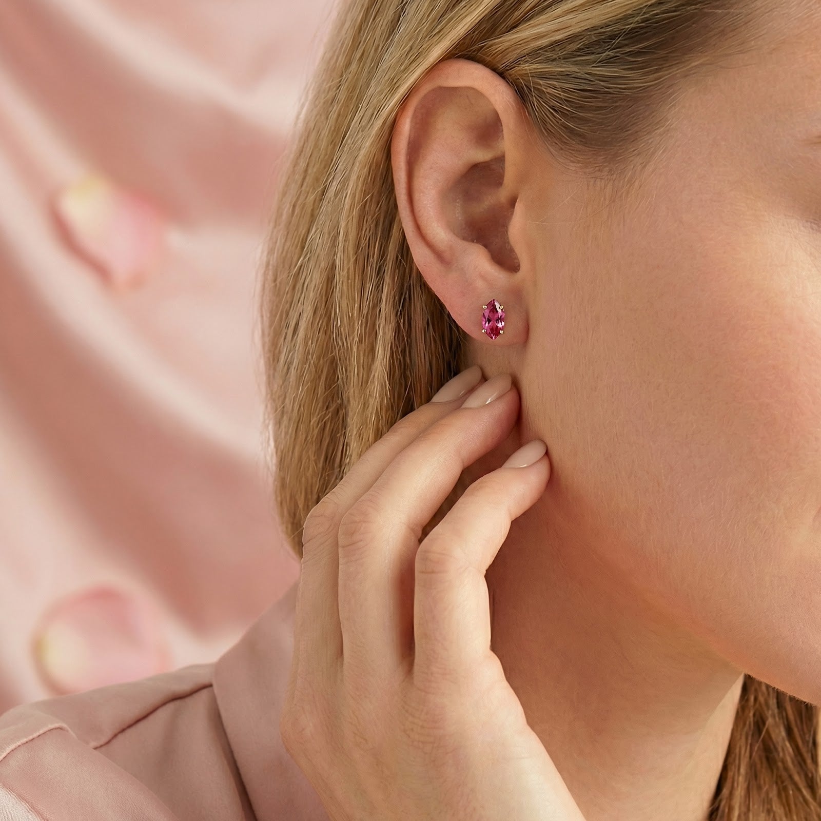 Side profile of a woman wearing a pink tourmaline marquise stud earring in 18K gold vermeil.