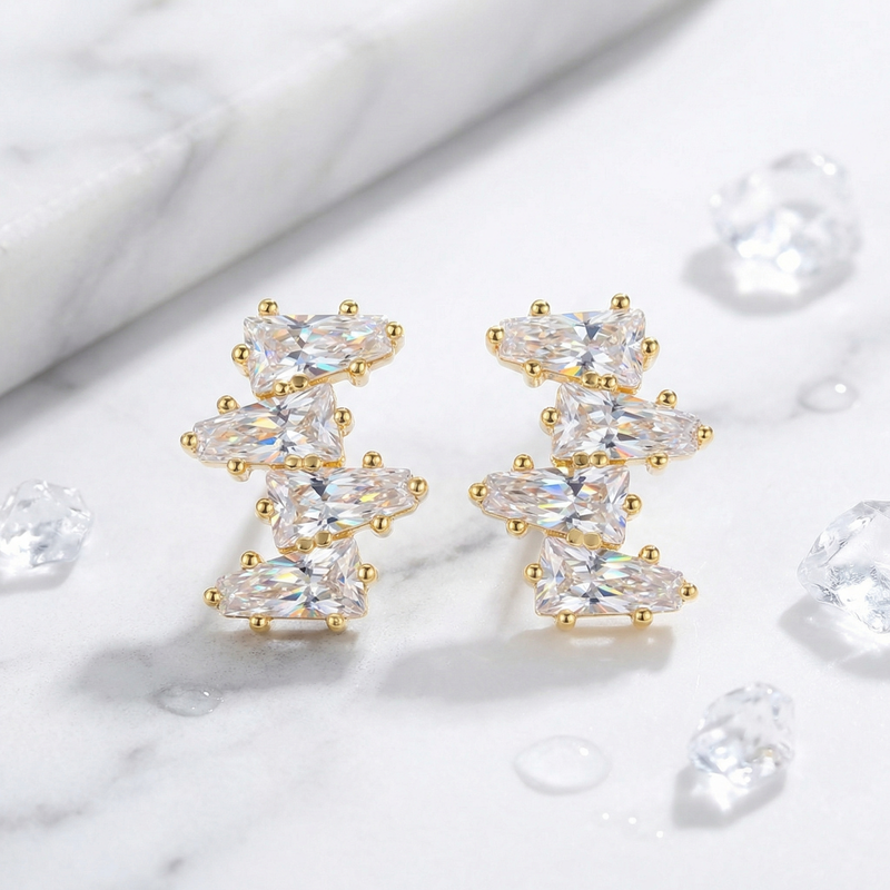 Detail view of 18K gold vermeil cluster earrings with precision-cut tapered baguette zirconia stones.